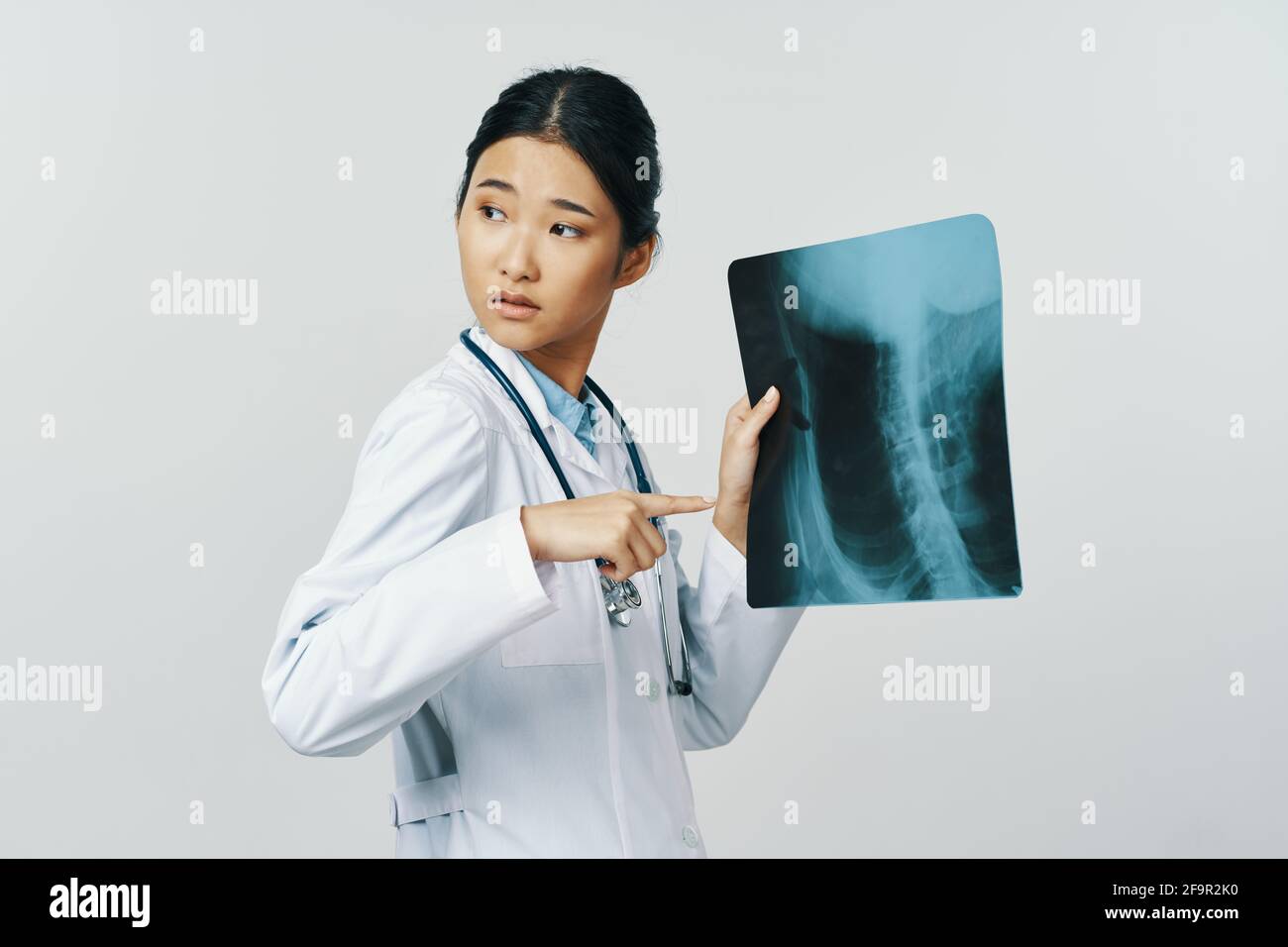 woman doctor in medical gown with xray in hand Stock Photo Alamy