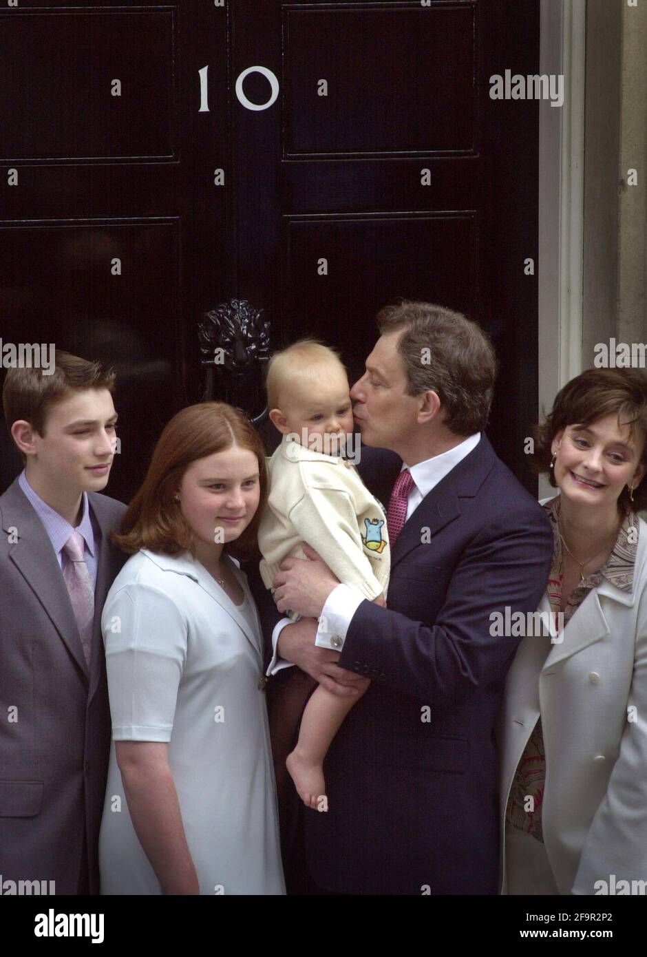 Prime Minister Tony Blair June 2001  with his family Nicholas (L), Kathryn (2L)kissing  infant Leo, Cherie (2R)  and Euan (R) stand outside No10 Downing Street June 8 2001.Tony  Blair swept to his second landslide election win Stock Photo