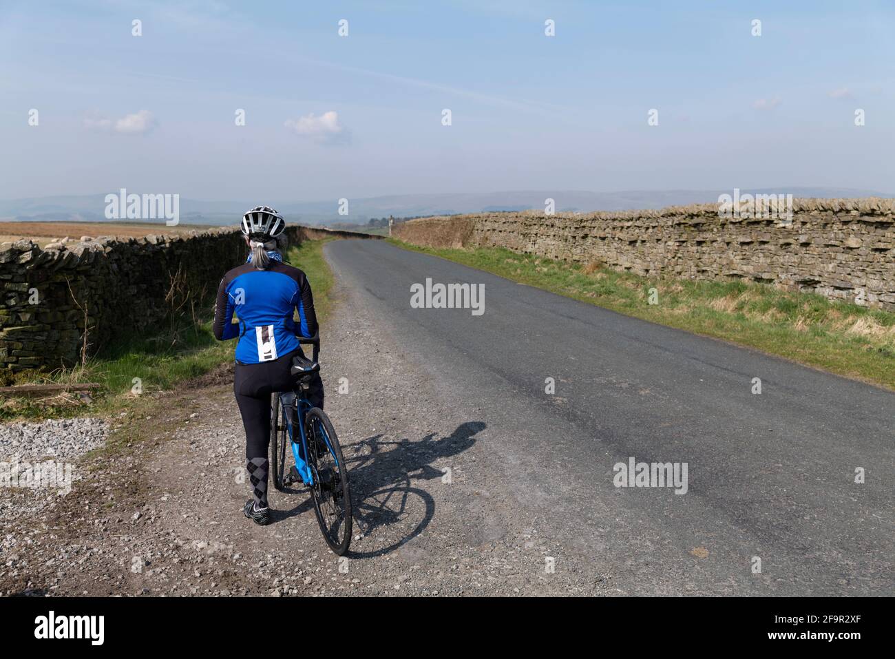 Female cyclist enjoying the spring weather in Bowland, Lancashire, UK. Stock Photo