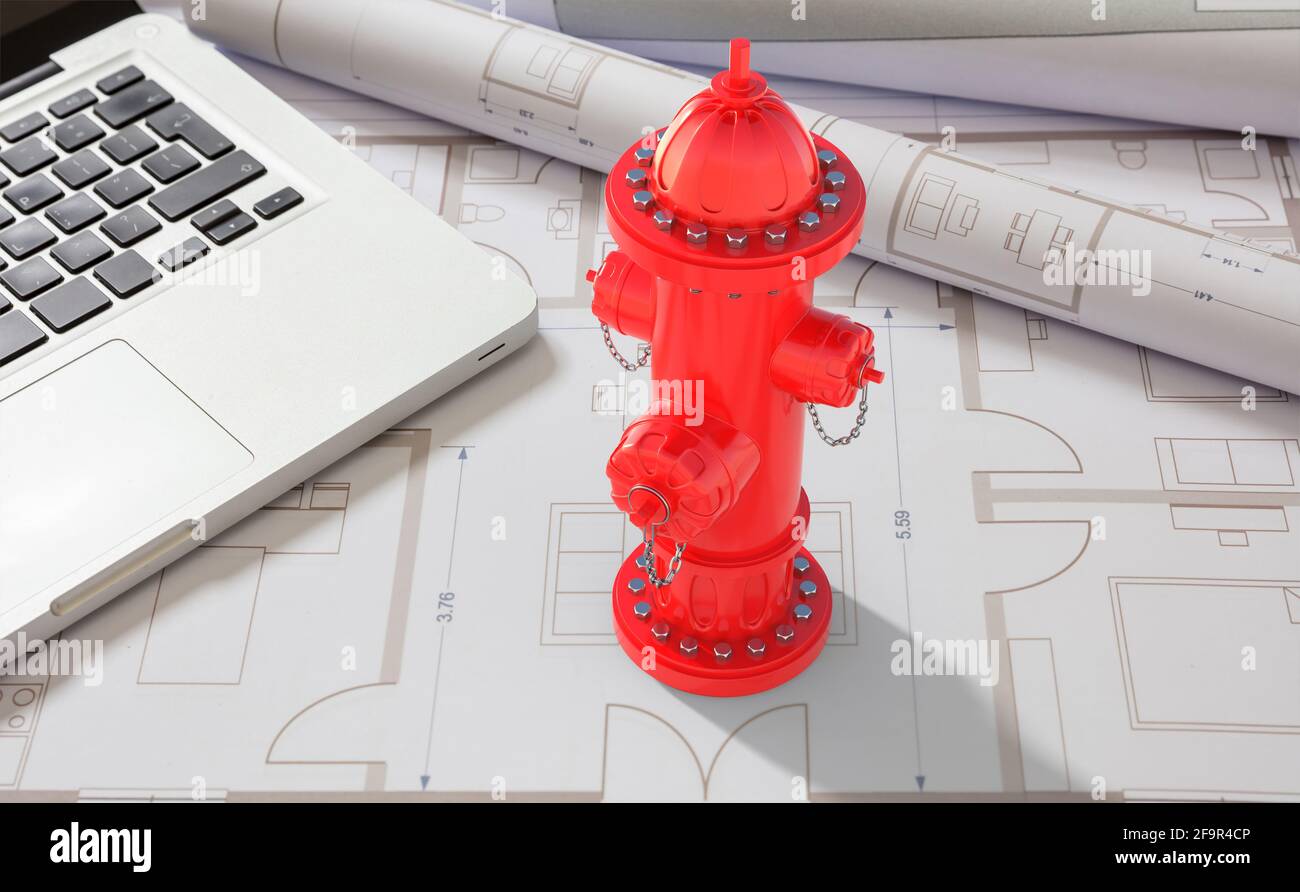 Fire hydrant red color and a computer laptop on blueprints drawings ...