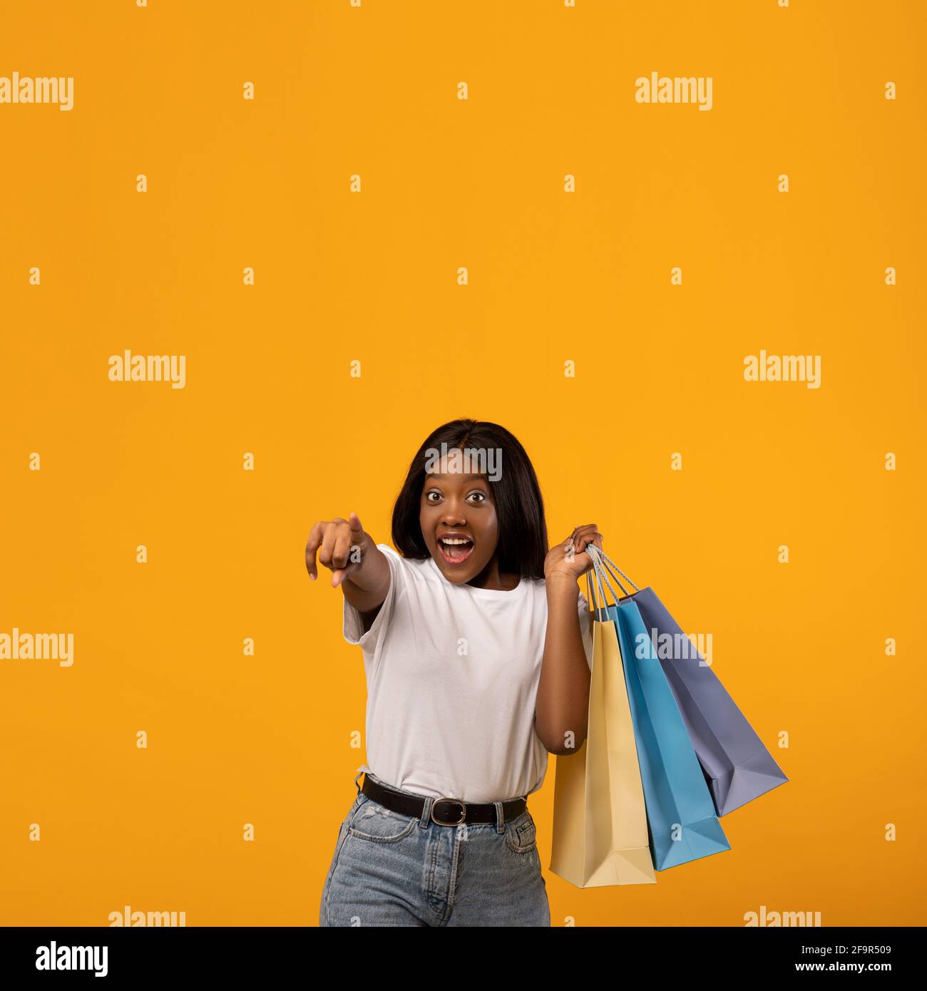 Emotional african american woman with shopping bags Stock Photo