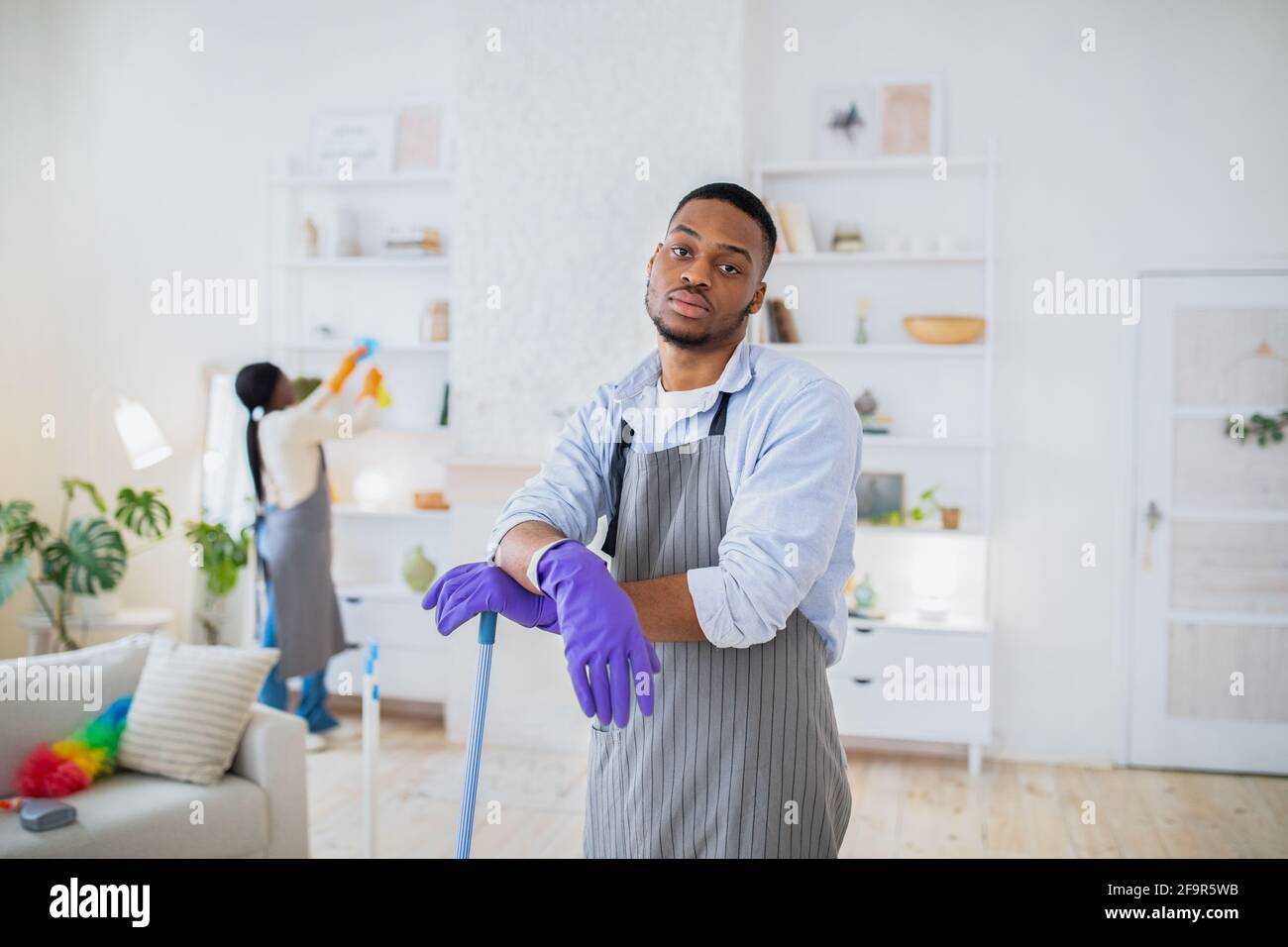 Too much domestic work. Tired black guy feeling bored of cleaning