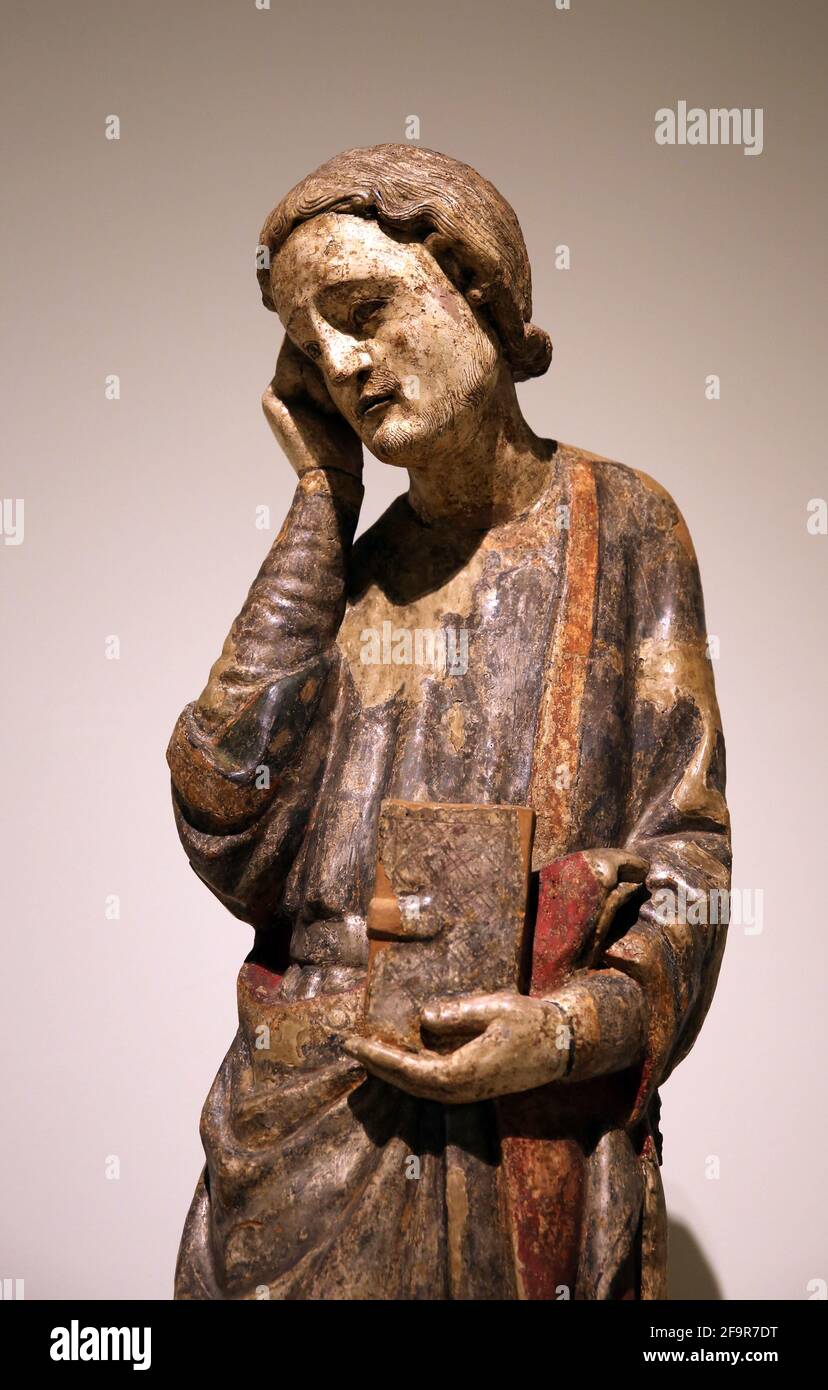 Statue. St. John the Evangelist.  Unknown provenance. 12th century. Carved pear wood with remains of polychromy. National Art Museum of Catalonia. Bar Stock Photo