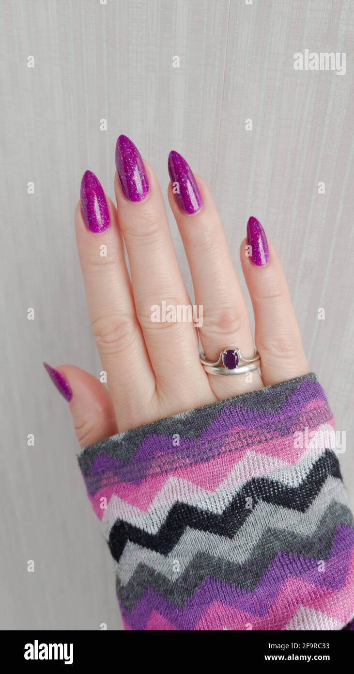 Female Hand With Long Nails And A Bottle Bright Neon Pink Red Color Nail Polish Stock Photo Alamy
