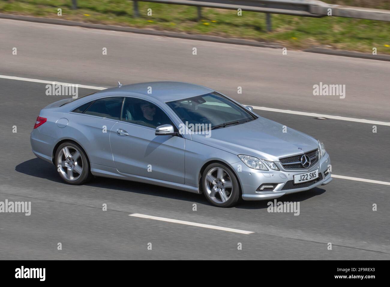 2010 MERCEDES-BENZ, E CLASS, E350 CDI BlueEFFICIENCY Sport 2dr Tip Auto; moving vehicles, cars, vehicle driving on UK roads, motors, motoring on the M6 English motorway road network Stock Photo