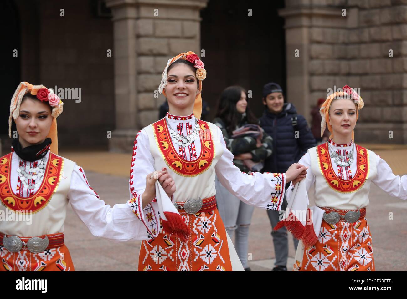 People in traditional folk costumes perform the Bulgarian folk dance "Horo" in the center of Sofia, Bulgaria Stock Photo
