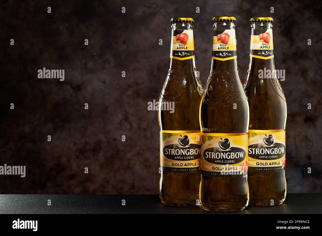 Tel-Aviv,Israel - 20.04.21. Gold Apple Cider light alcoholic beverage on a dark background. Stock Photo