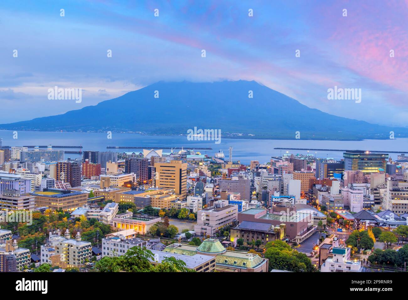 Kagoshima city downtown skyline cityscape  with Sakurajima Volca Stock Photo