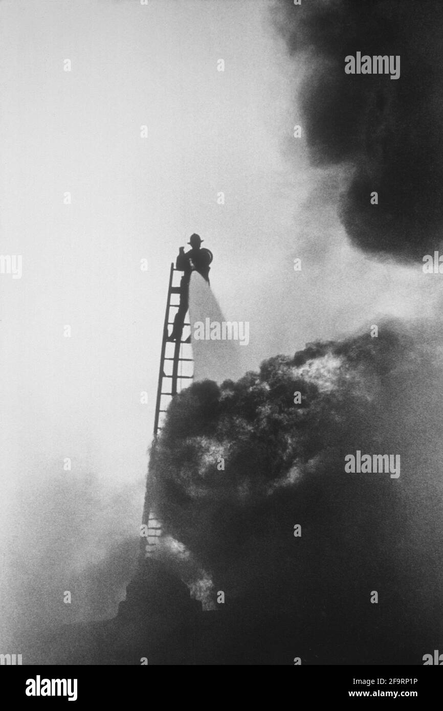 Fighfighter battles blaze in Miami, Florida, Ca. 1960's. Stock Photo