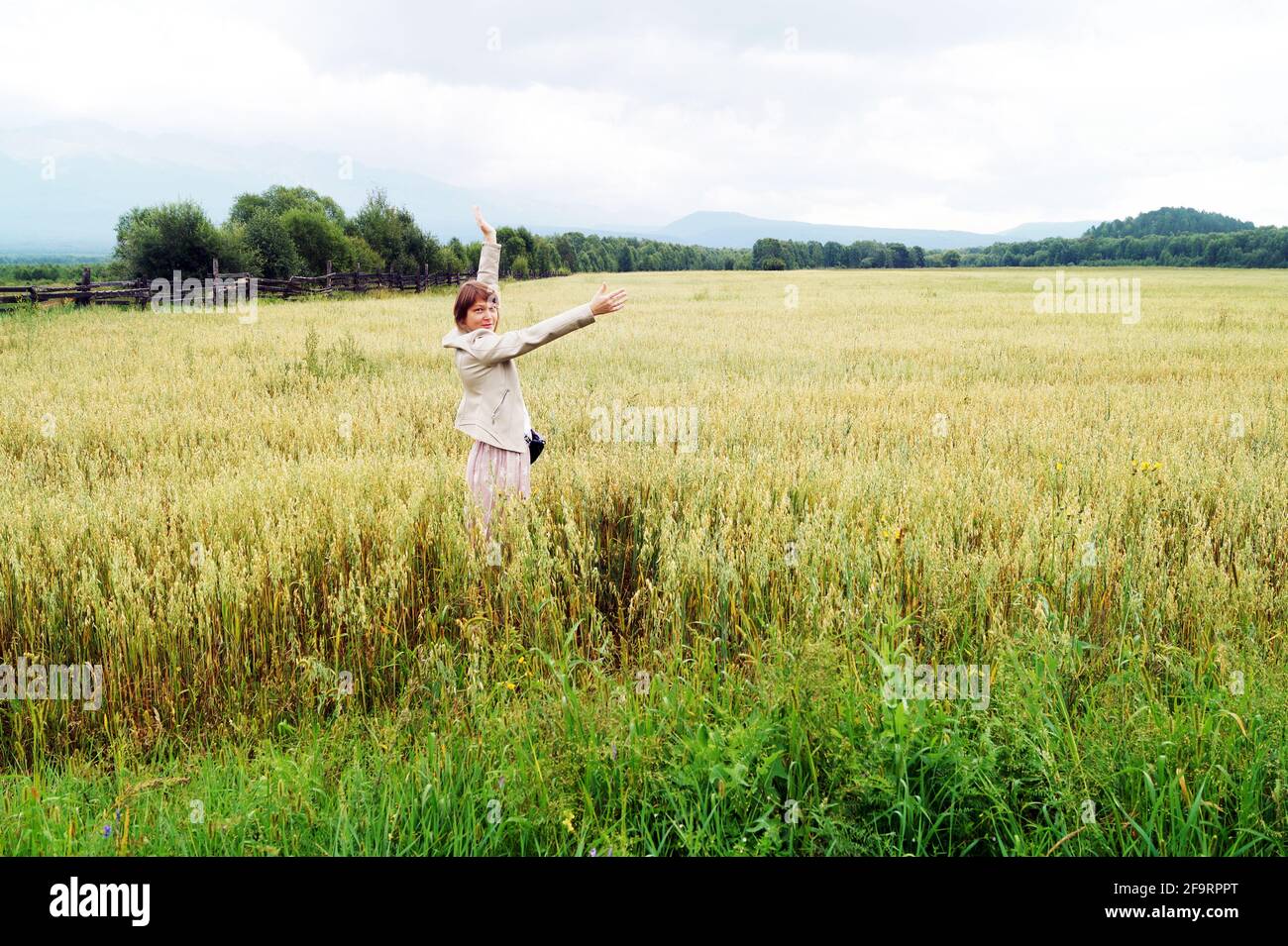A 35-40-year-old woman in a field in the Sayan Mountains Stock Photo