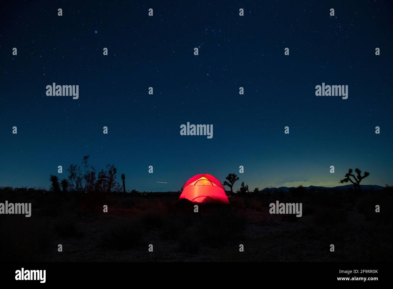 illuminated camping tent in desert under starry sky Stock Photo - Alamy