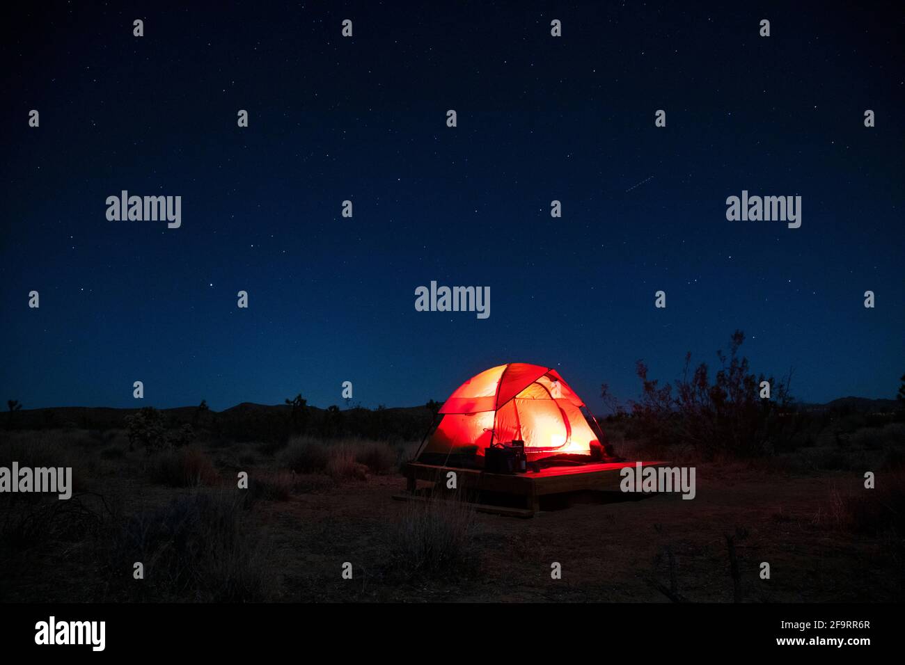 illuminated tent on camping platform in desert under starry sky Stock ...