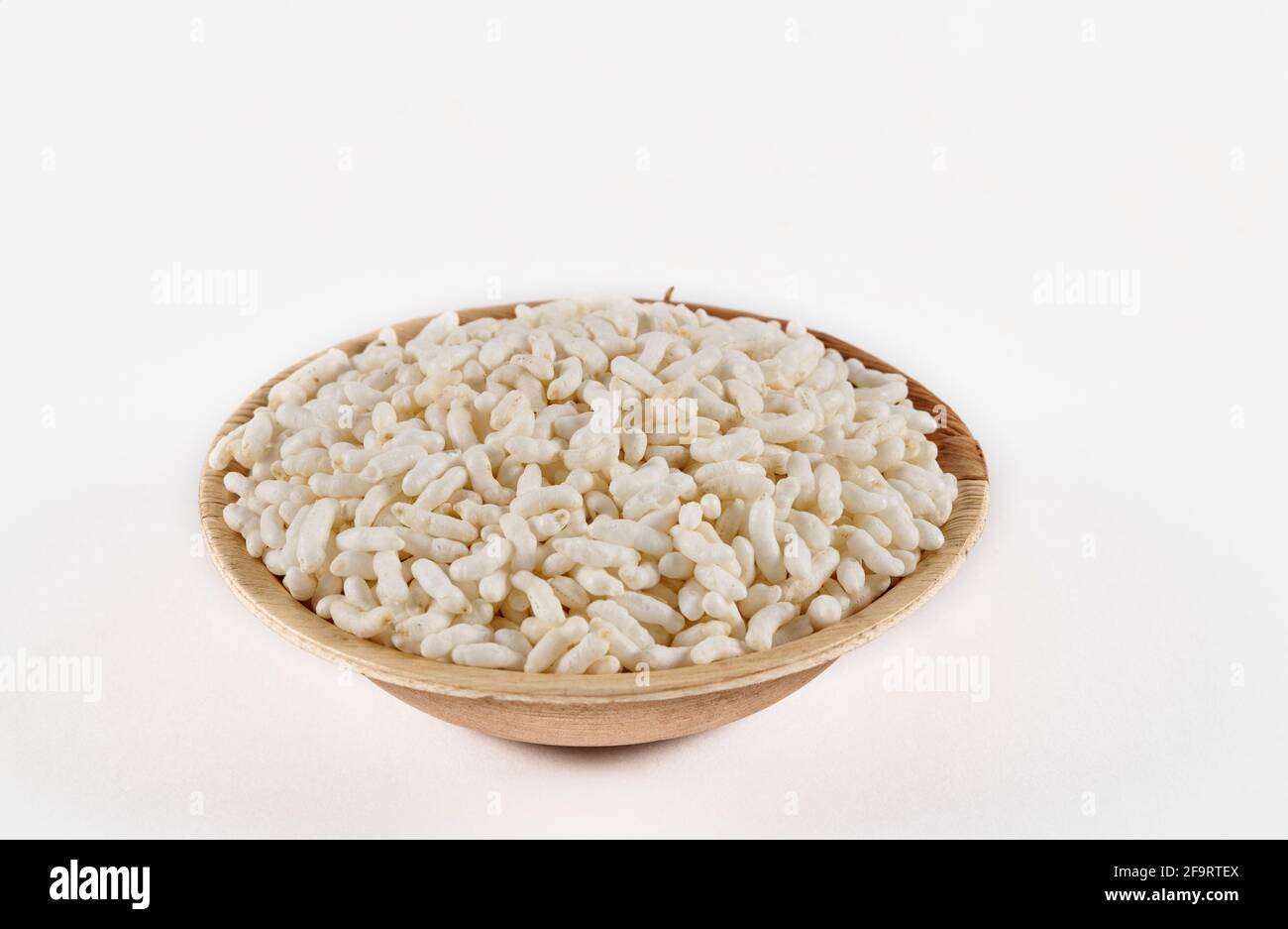 Puffed rice in an areca leaf bowl on a white background Stock Photo