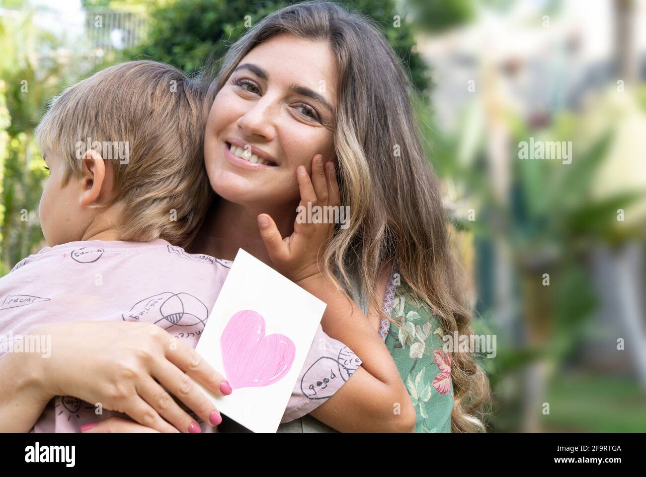 Mother Playing With Her Son In Garden Stock Photo Alamy