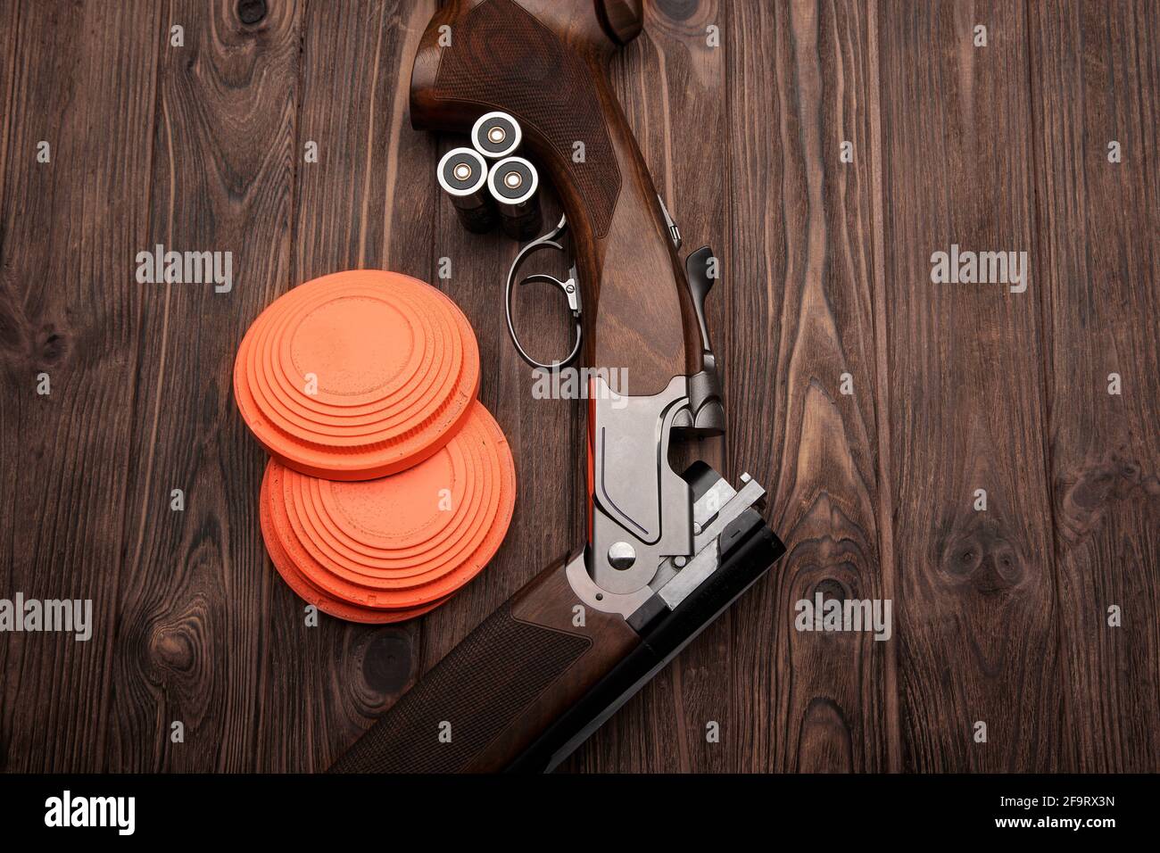 Clay target plates for shooting with rifle on wooden background Stock
