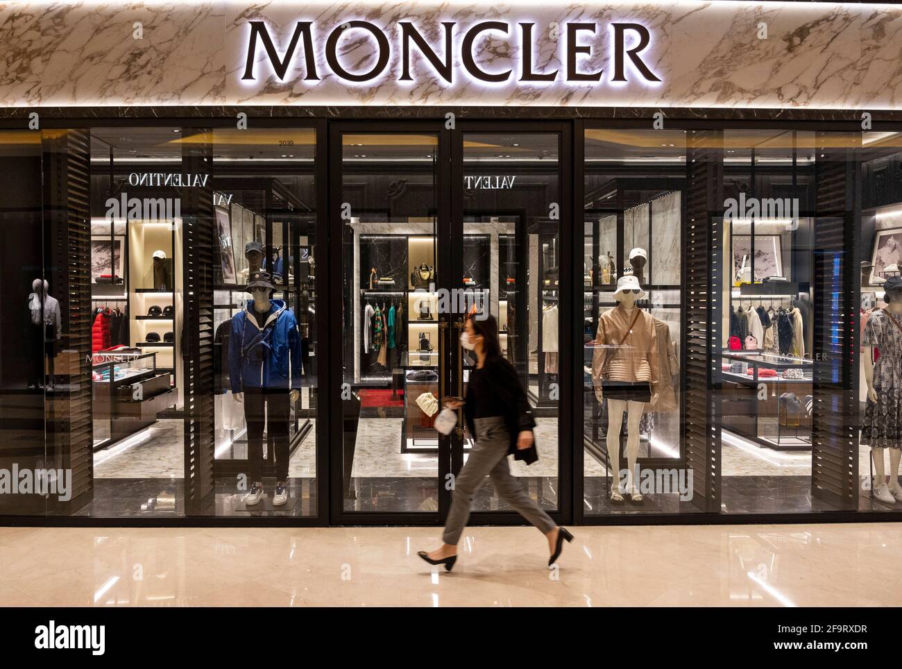 Hong Kong, China. 20th Apr, 2021. A woman walks past the Italian luxury  fashion brand Moncler