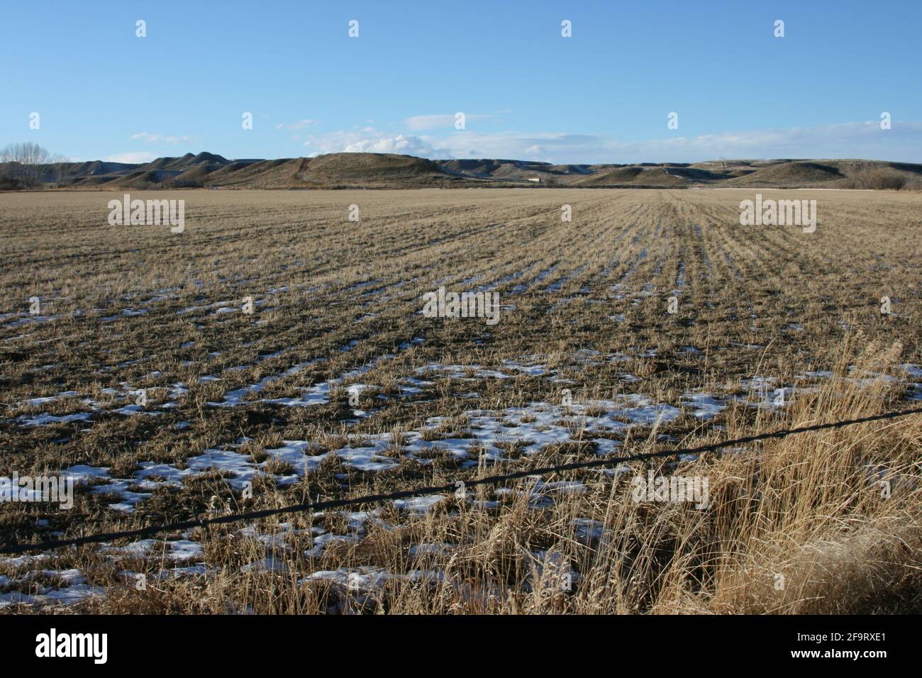 Photo inspiration: Picture Idea: Large Dry Agricultural Field Covered By Snow Under The Blue