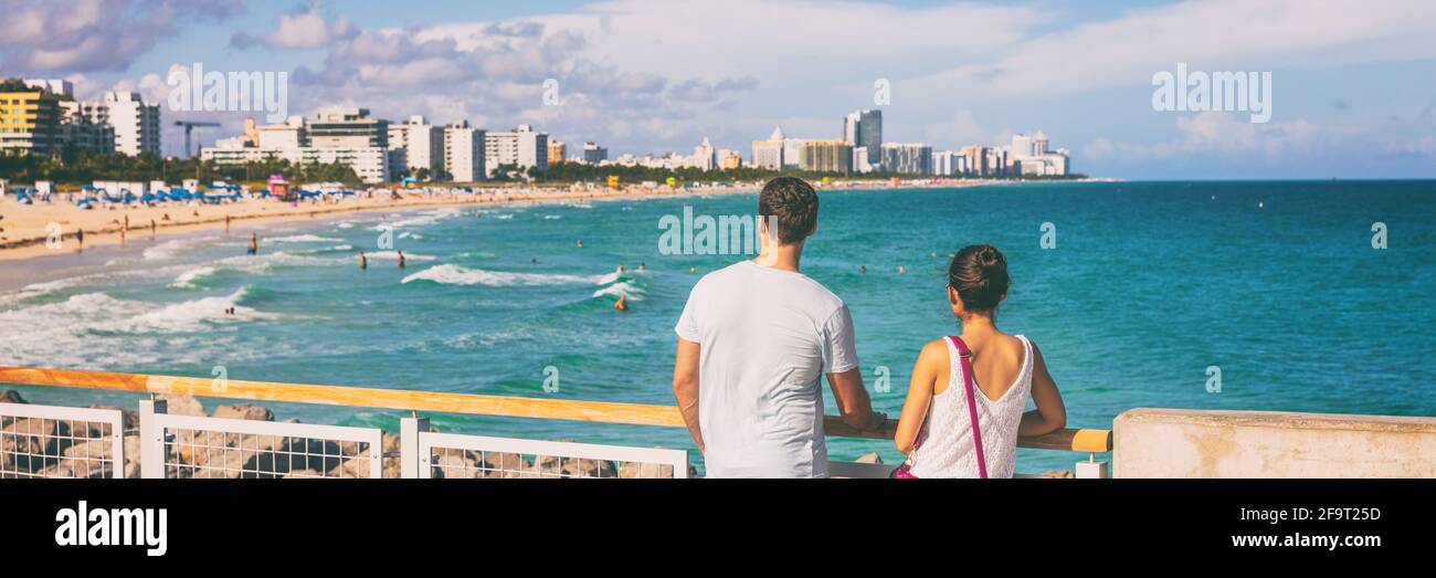 Miami beach people lifestyle young tourists couple walking in South Beach, Miami, Florida. USA travel. Panoramic banner background Stock Photo