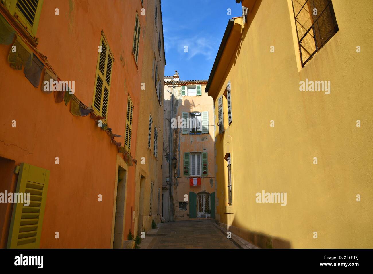 Typical Provençal style houses with ochre stucco walls in the historic center of Saint-Tropez, French Riviera France. Stock Photo