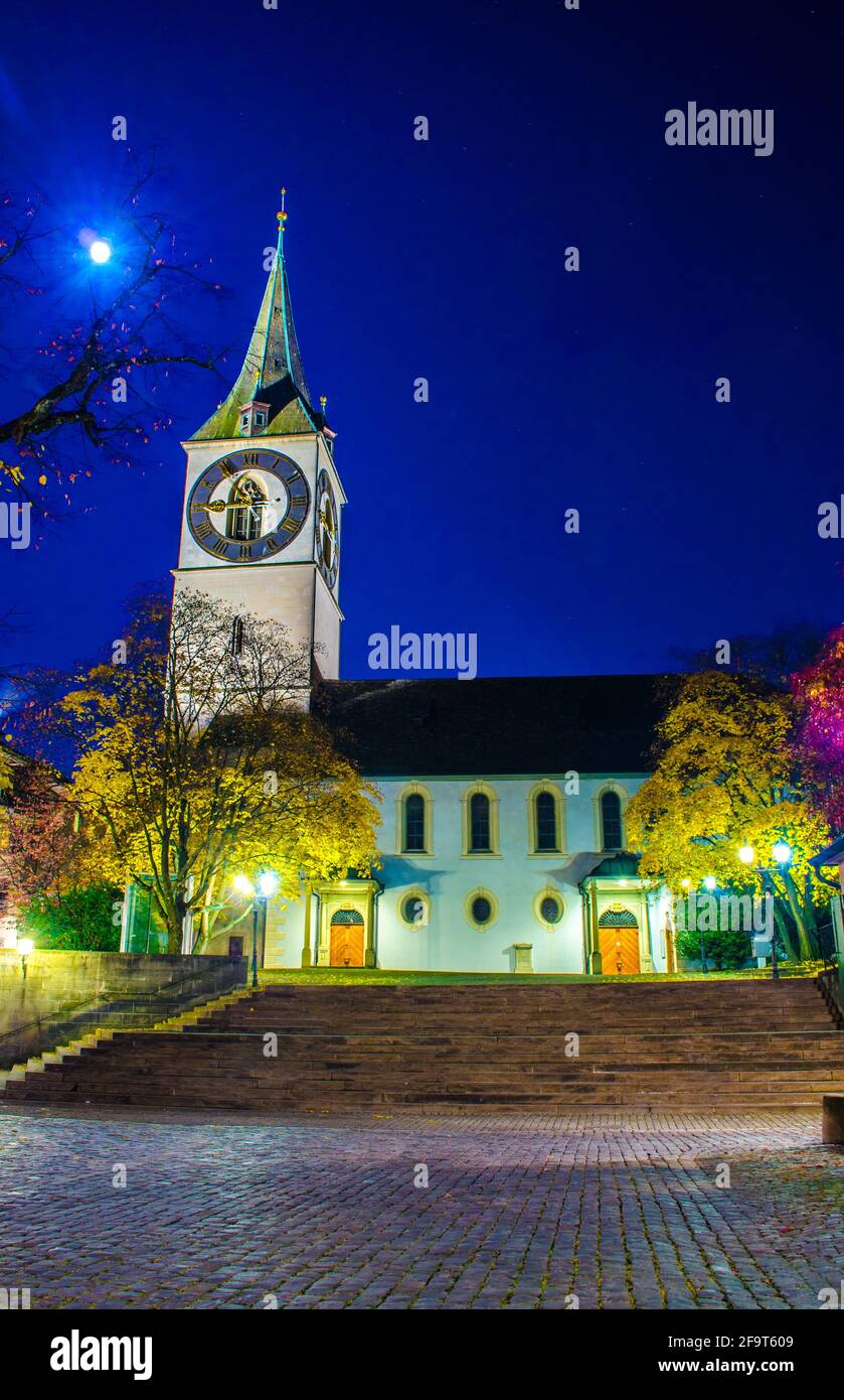 View of the church of saint peter in swiss city zurich during night Stock Photo