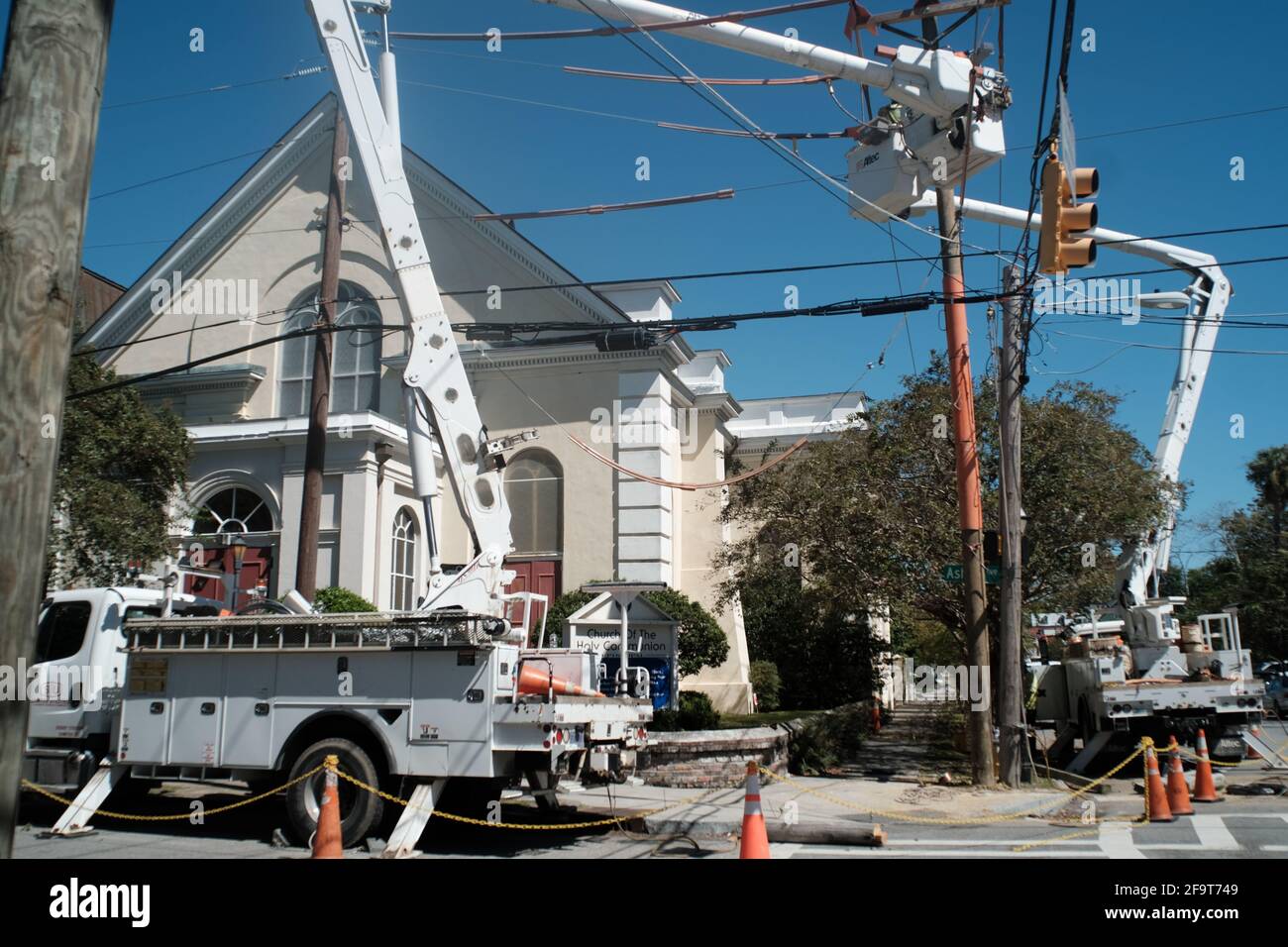 street scene, including eyes flag of group utility electrical poles being serviced. Stock Photo
