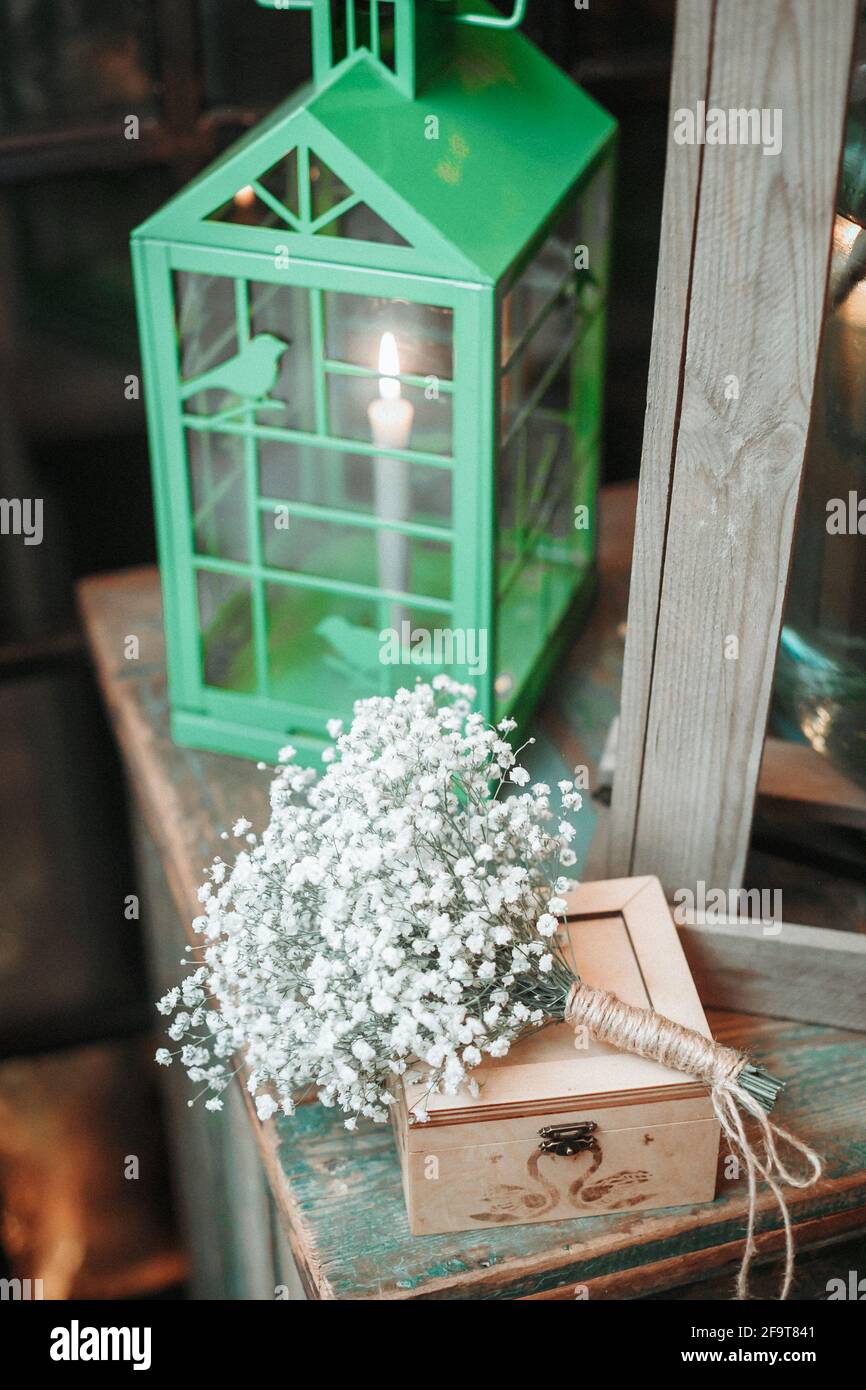 wooden box for wedding rings next to the lantern. Stock Photo