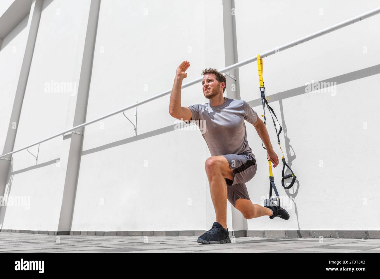 Fitness suspension straps man training legs lunge Stock Photo Alamy