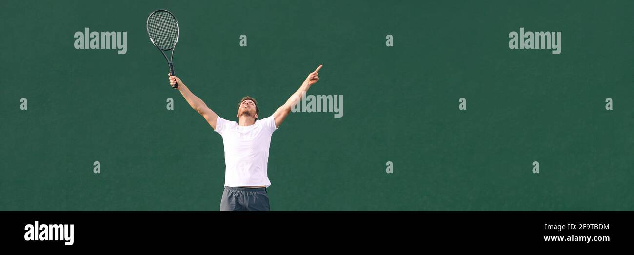 Tennis player man winning cheering celebrating victory in match point. Winner male athlete happy with arms up to the sky in celebration of success and Stock Photo