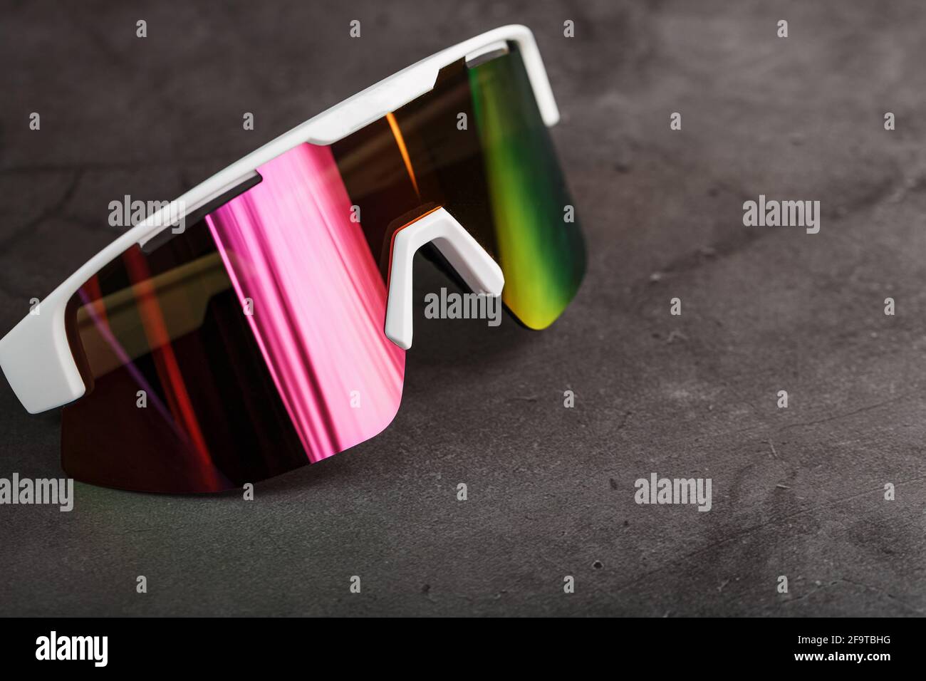 Red sports glasses with a mirror lens on a dark background. Free space Stock Photo Alamy