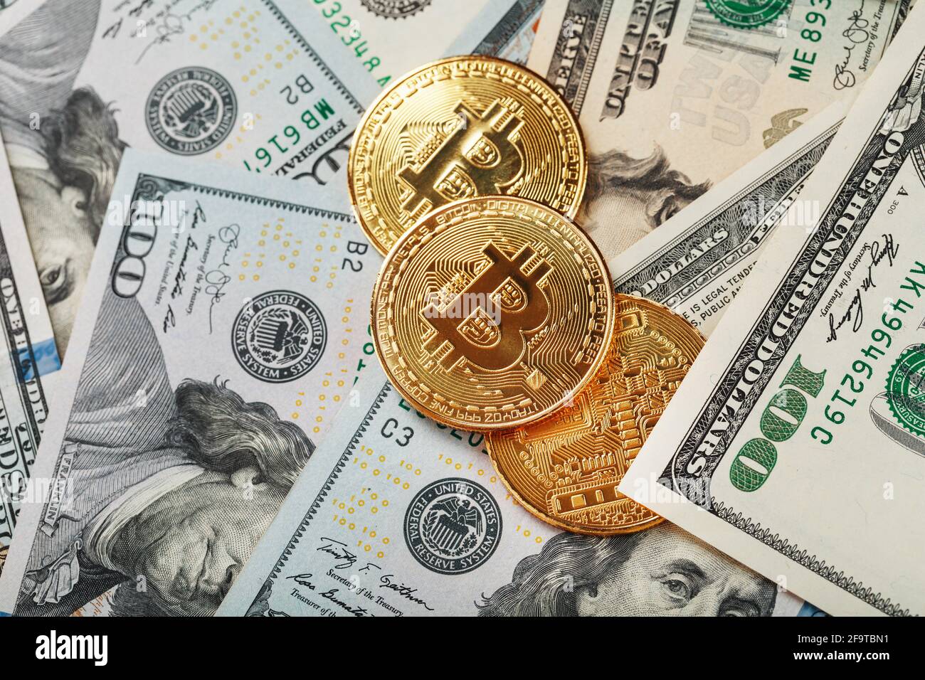 over dollar banknotes. CrypGold bitcoin coins on the background of dollar  bills with the concept of the exchange rate of the financial markets.  Bitcoi Stock Photo - Alamy