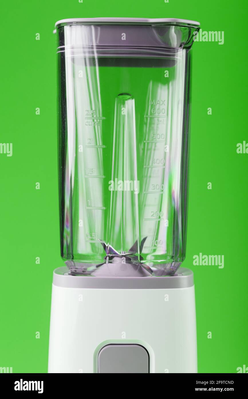 A white blender with an empty glass on a green background. Kitchen  appliances for cooking delicious and healthy food. Free spaceoo Stock Photo  - Alamy