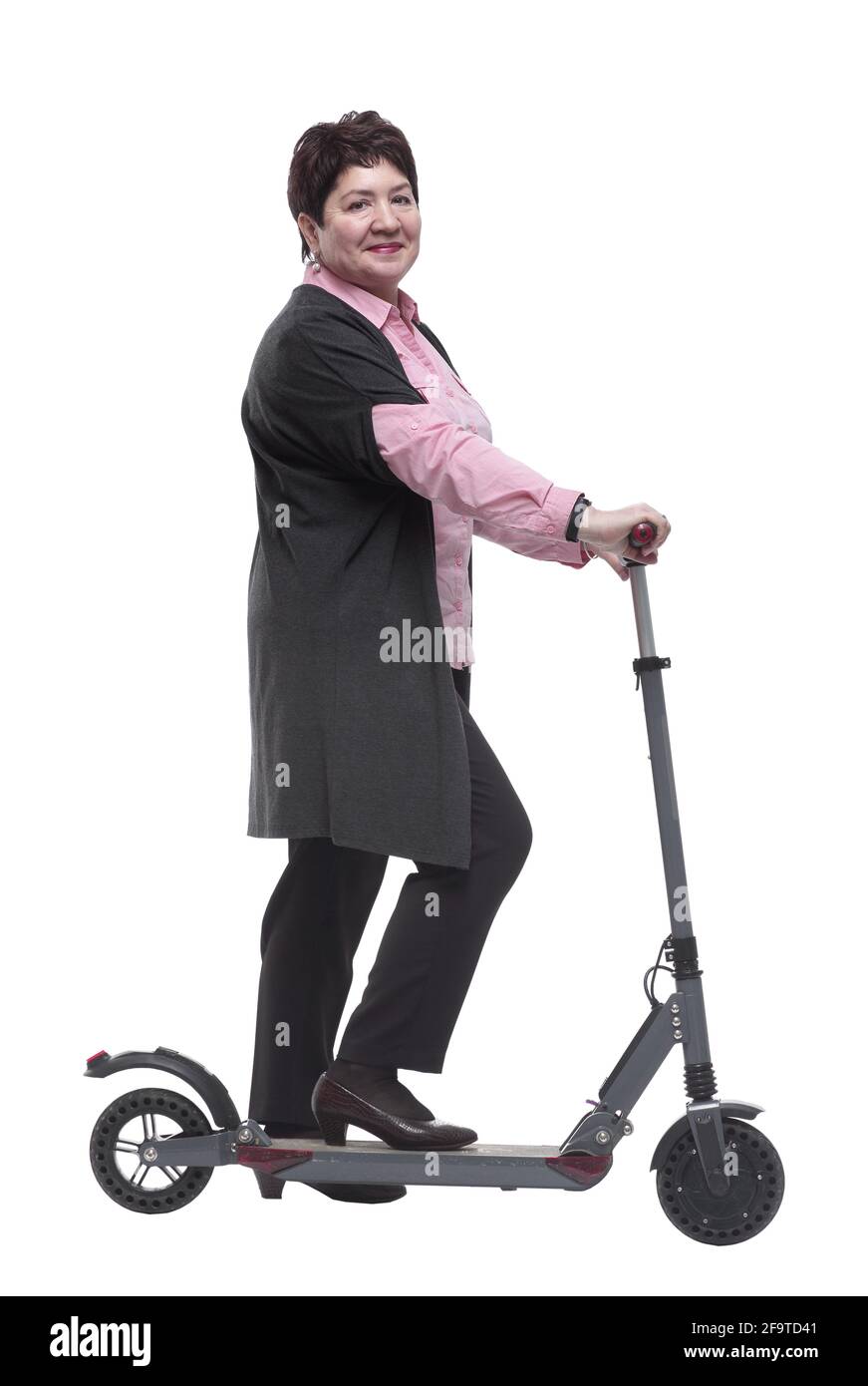 side view. mature woman with an electric scooter reading an ad on a