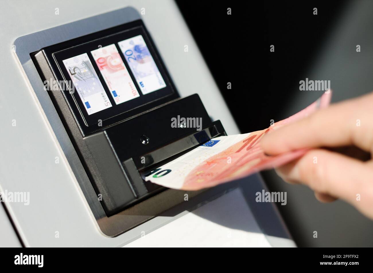 Person banknote money payment process at cash vendor vending exchange automat  machine with euro currency Stock Photo