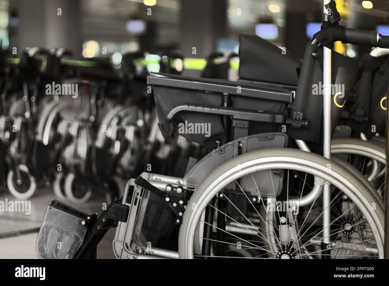 Wheelchair service assistance wheelchairs for mobility wheel chair users at airport terminal Stock Photo