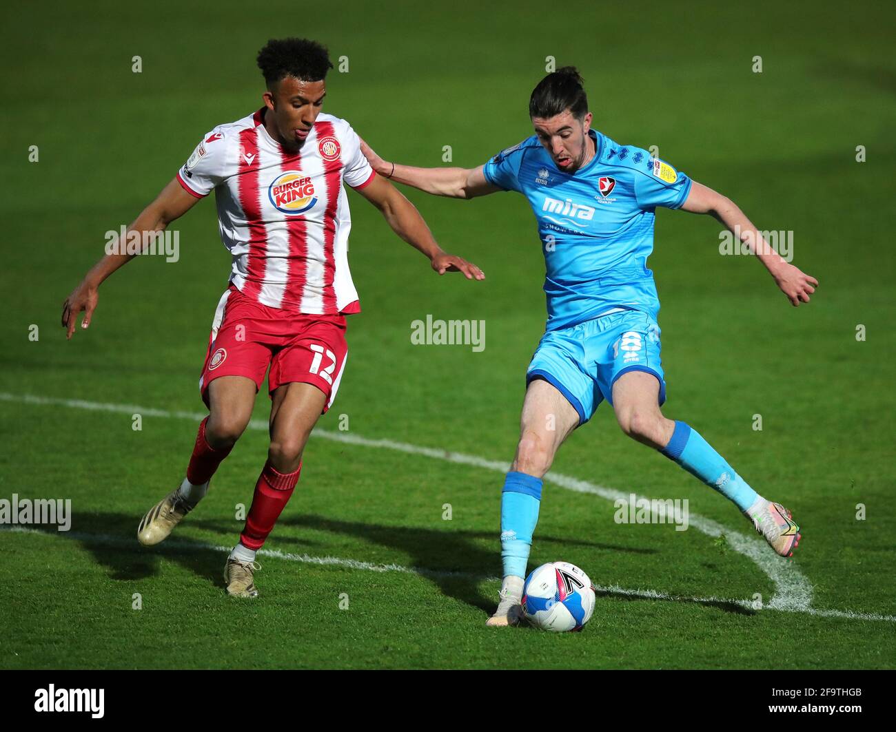 Stevenage's Remeao Hutton (left) and Cheltenham Town's Finn Azaz battle for the ball during the Sky Bet League Two match at the Lamex Stadium, Stevenage. Picture date: Tuesday April 20, 2021. Stock Photo