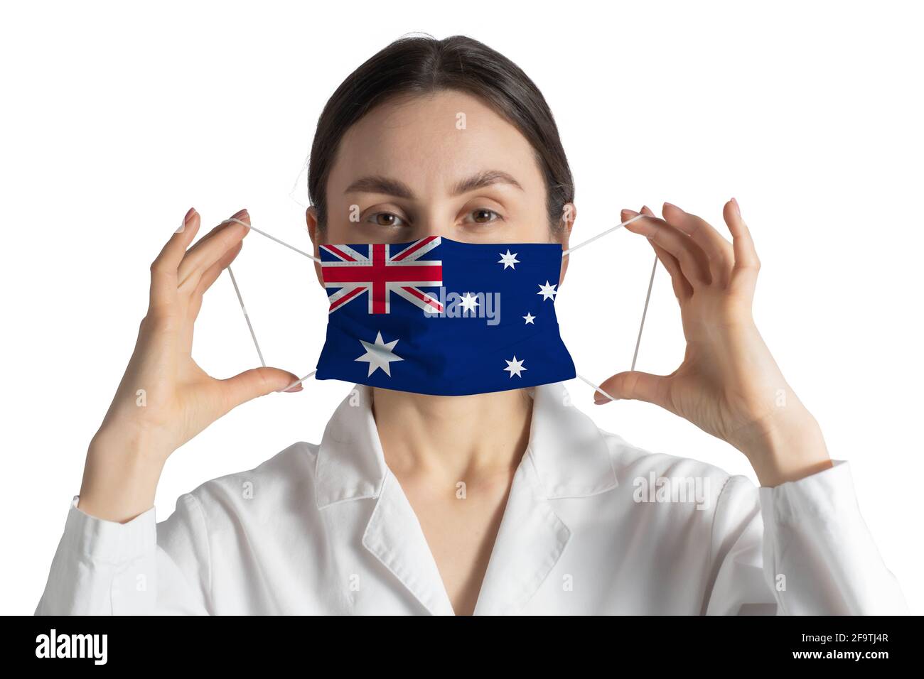 Respirator with flag of Australia Doctor puts on medical face mask isolated on white background. Stock Photo