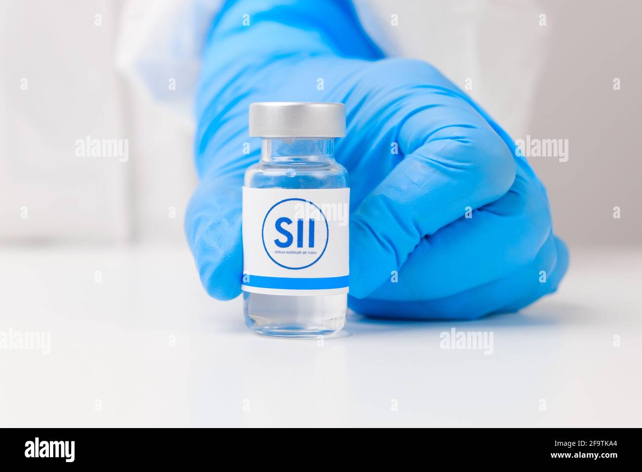 SII vial or bottle with pharmaceuticals demonstrated by health worker or scientist in rubber gloves, April 2021, San Francisco, USA  Stock Photo