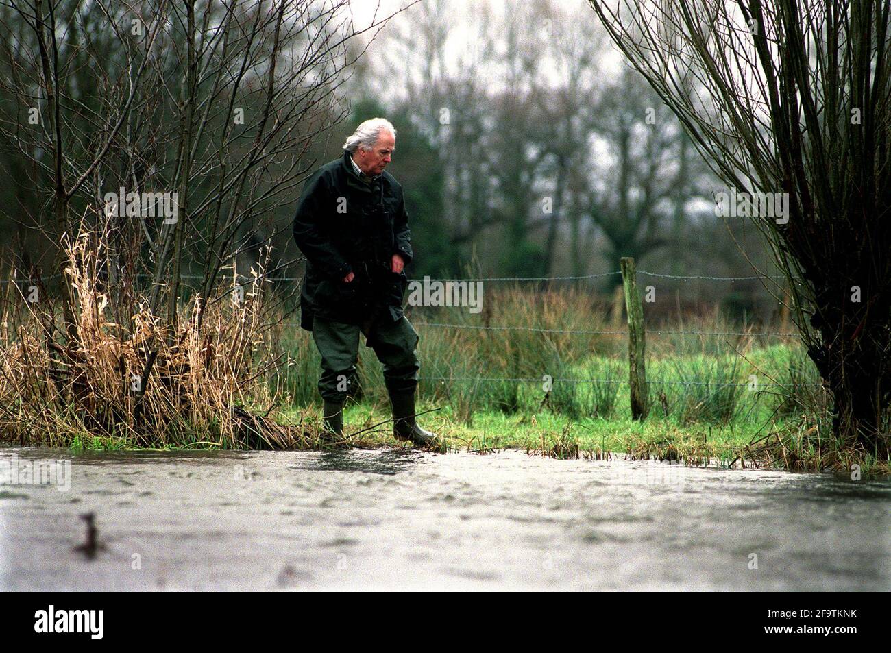 WRITER BRIAN CLARKE  FEB 2001  BY AN UNUSUALLY SWOLLEN RIVER MEON IN HAMPSHIRE. Stock Photo