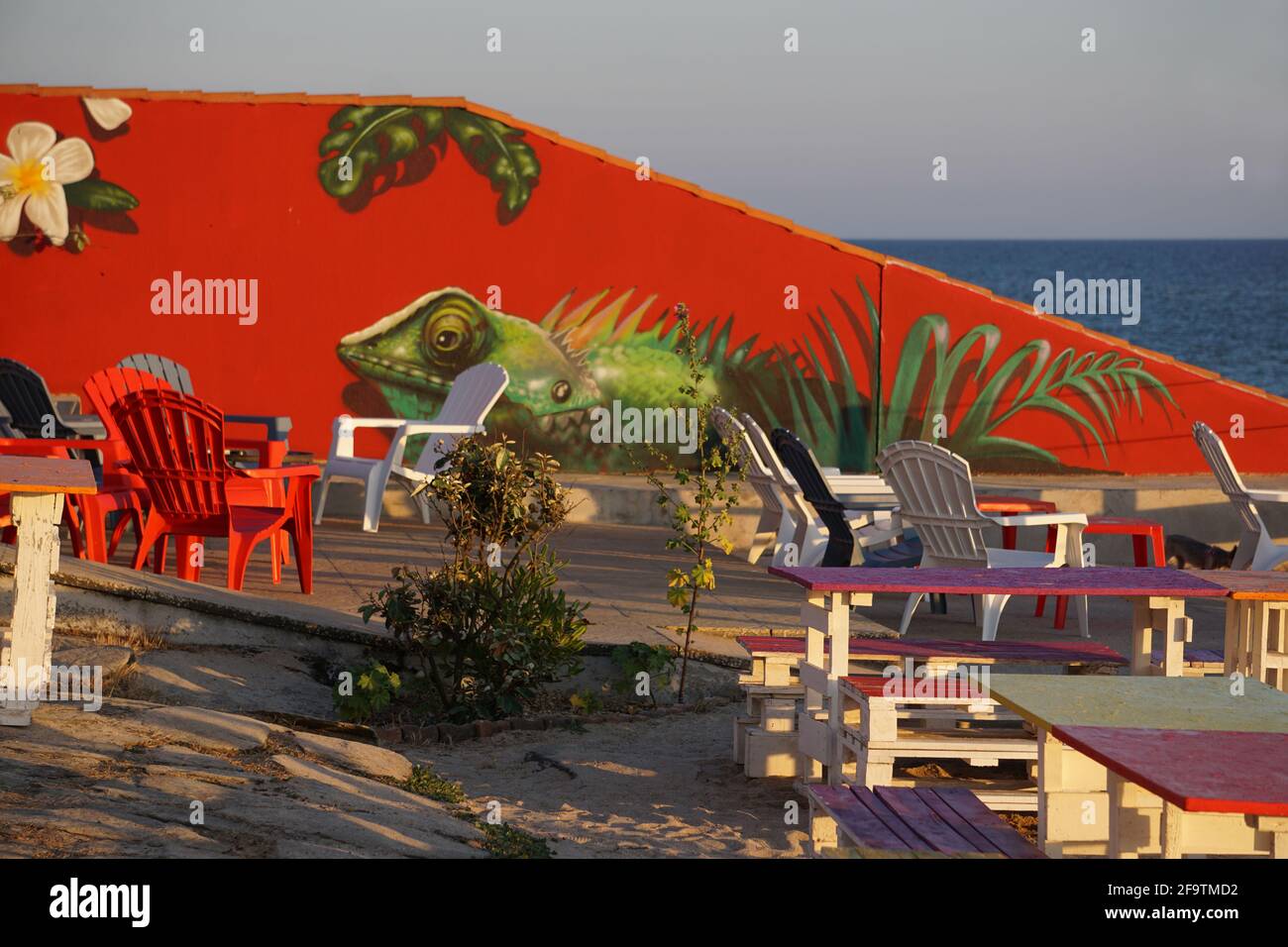 colorful artwork wall on the terrace of an outdoor restaurant on the west coast of France with an ocean view Stock Photo