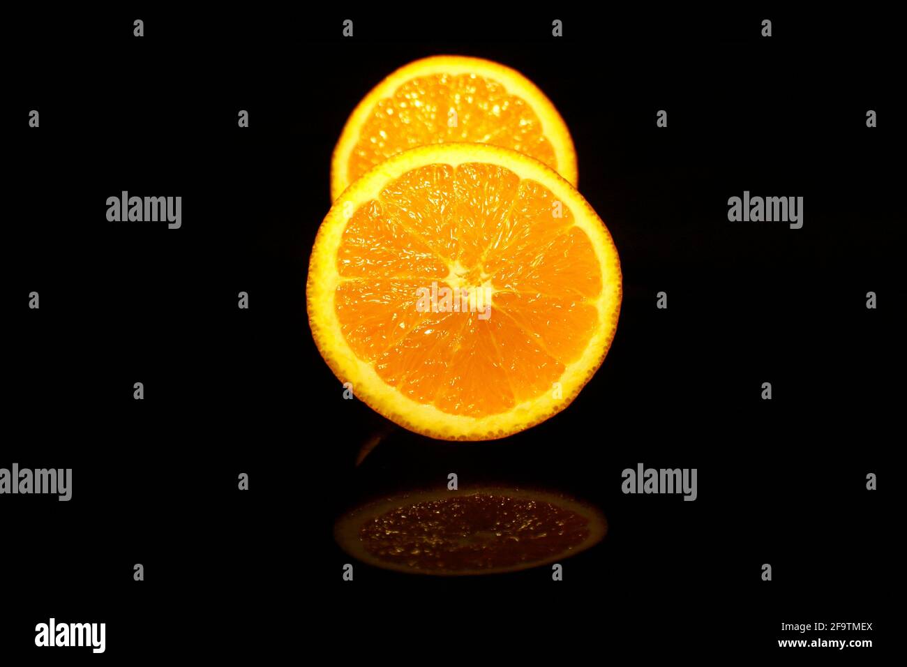 Two half oranges isolated on black Stock Photo