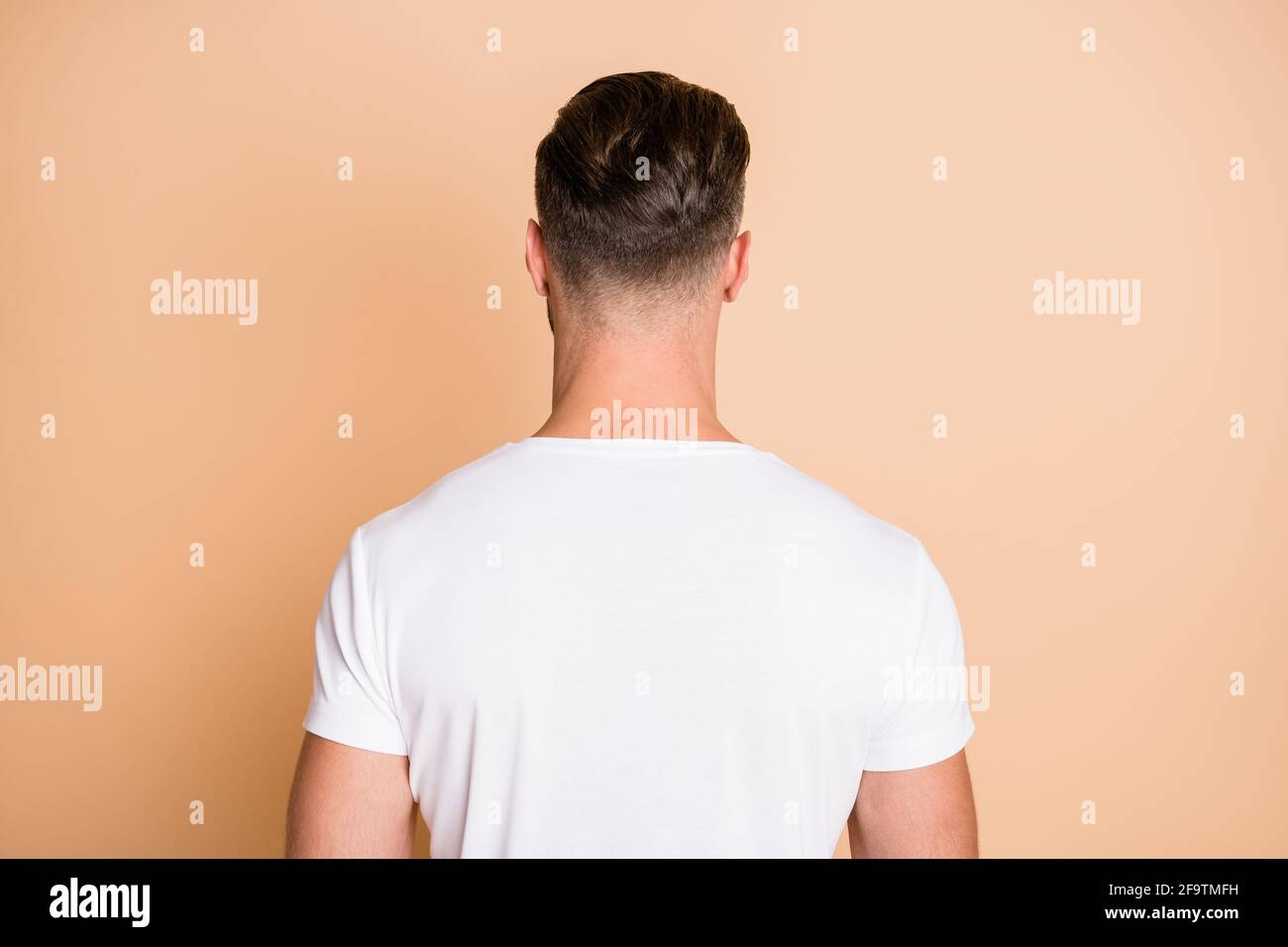 Rear back behind view portrait of nice attractive guy wearing modern ...