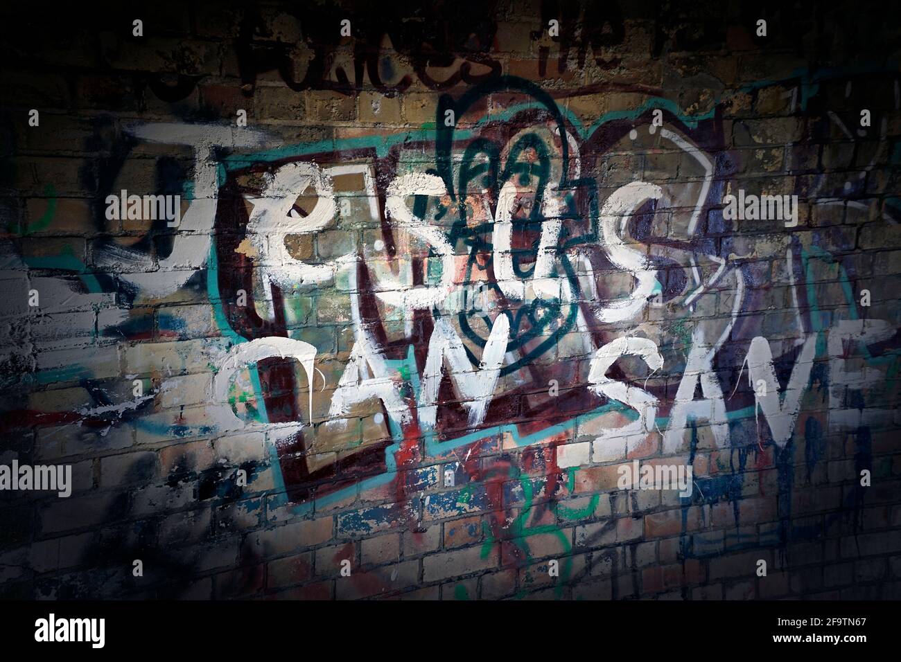 religious graffitti on wall of redundant coastal air raid sheltergraffiti Stock Photo