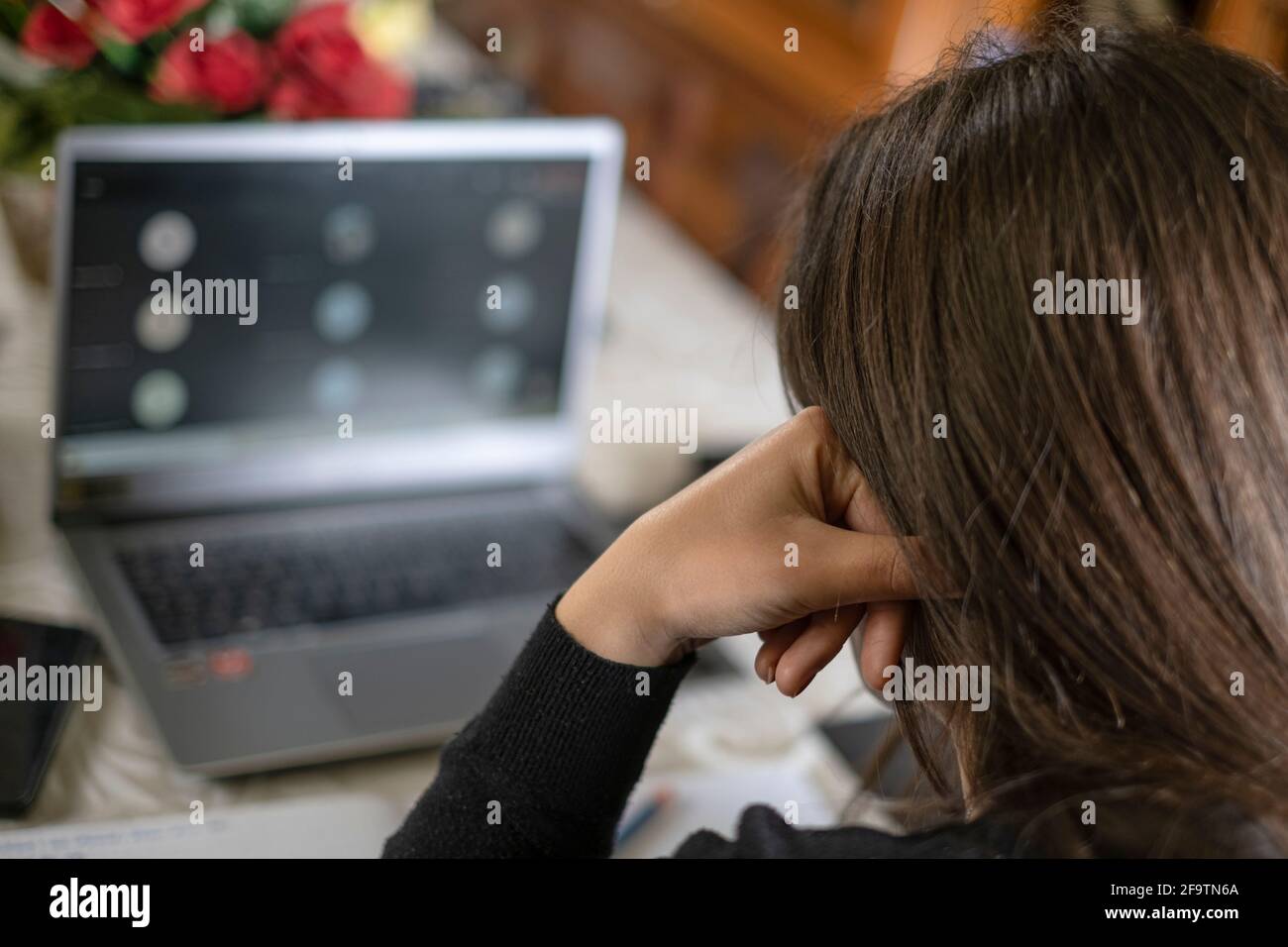 Stressed Woman studying at home while use notebook for remote schooling video call,covid-19 pandemic Stock Photo