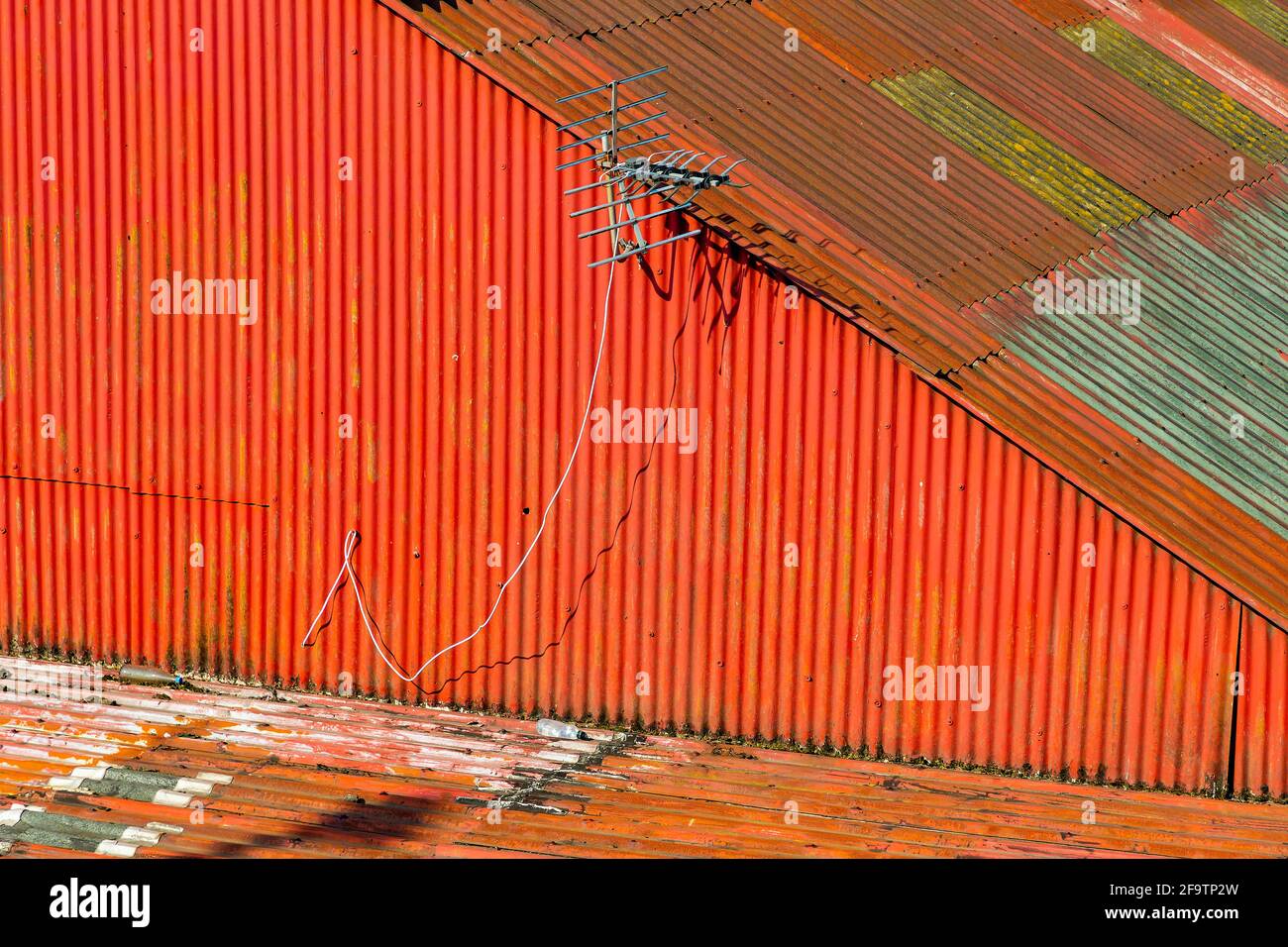 Weatherbeaten red corrugated tin roof above business premises Stock Photo Alamy
