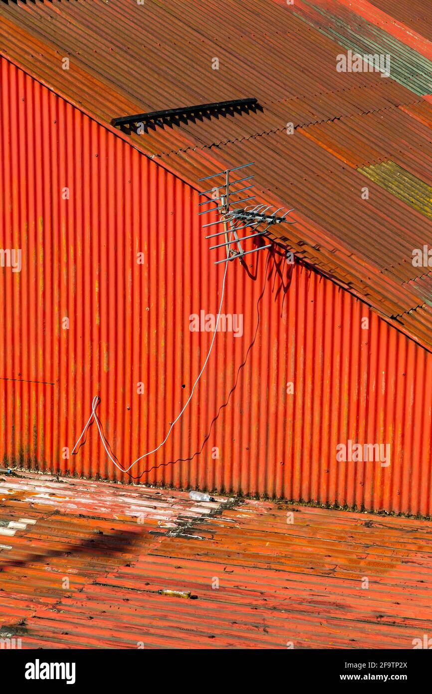 Weatherbeaten red corrugated tin roof above business premises Stock Photo Alamy