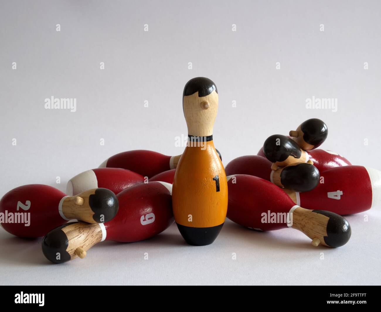 conceptual photo: all players are grounded defeated, only number one remains standing in front of the camera Stock Photo