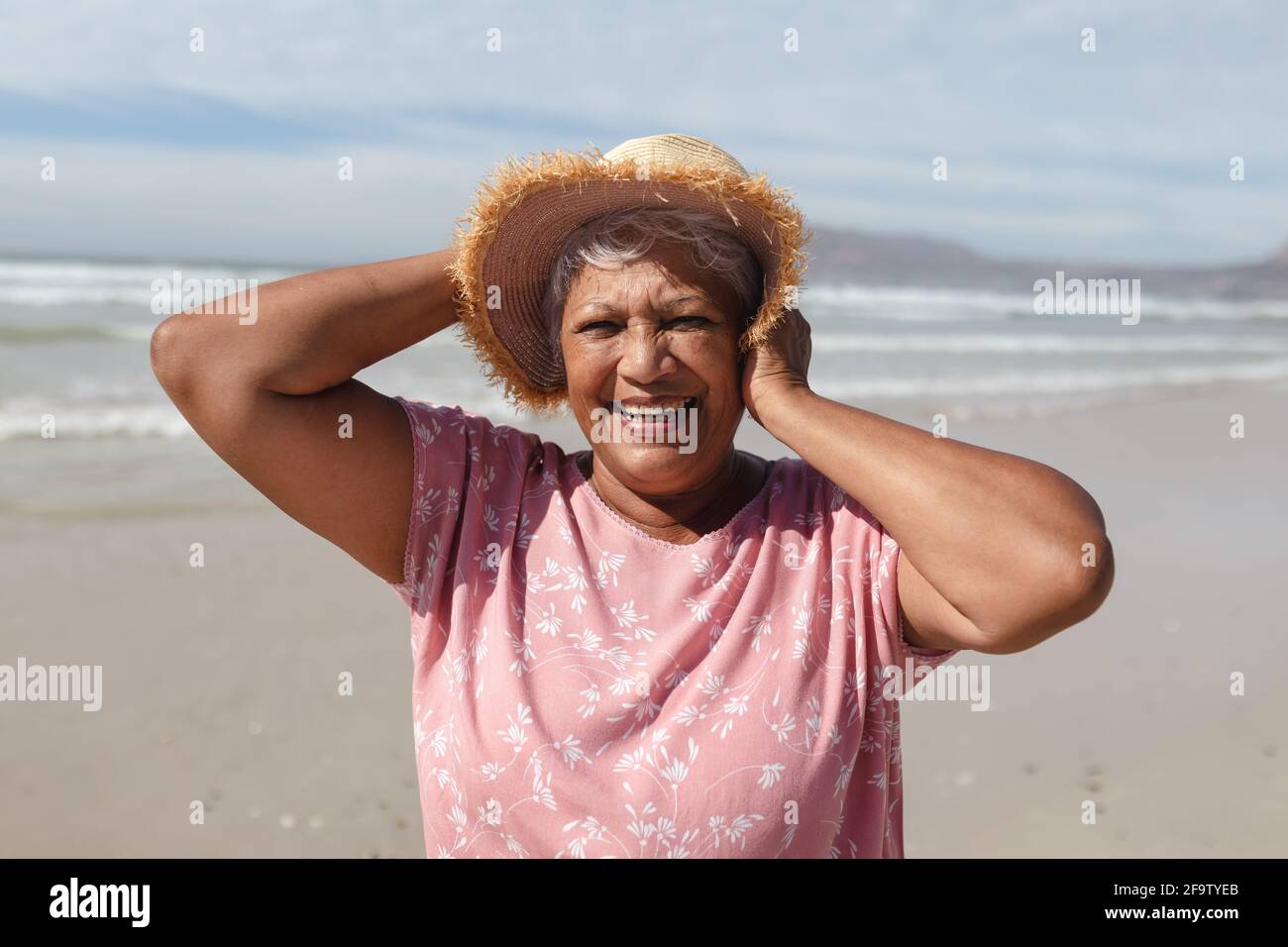 Portrait of senior african american woman smiling on the beach Stock ...