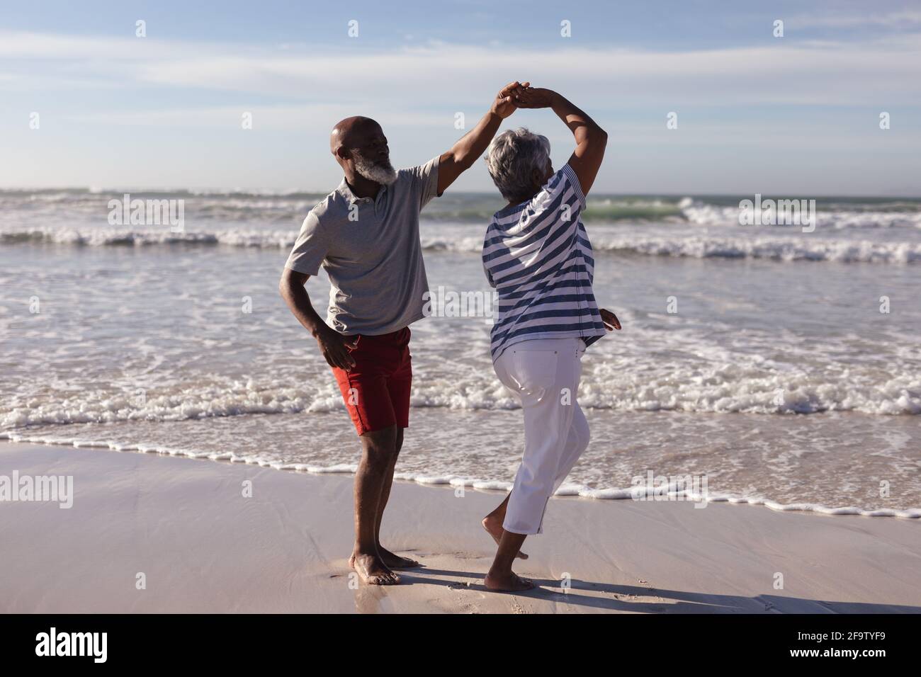 Happy senior african american couple dancing together on the beach ...