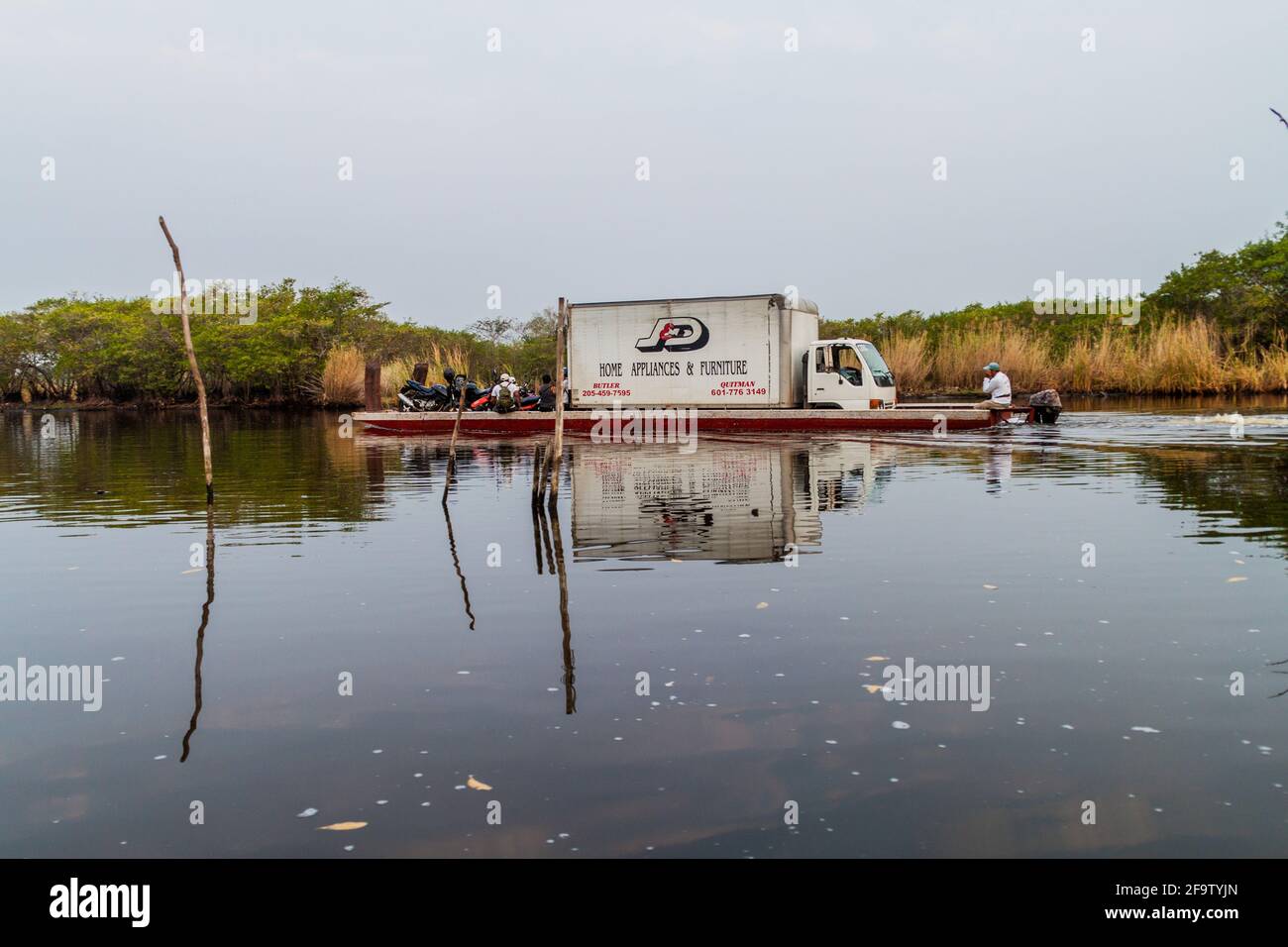 MONTERRICO, GUATEMALA - MARCH 30, 2016: Ferry loaded with a truck in the wetlands of the wildlife reserve Biotopo Monterrico-Hawaii, Guatemala Stock Photo