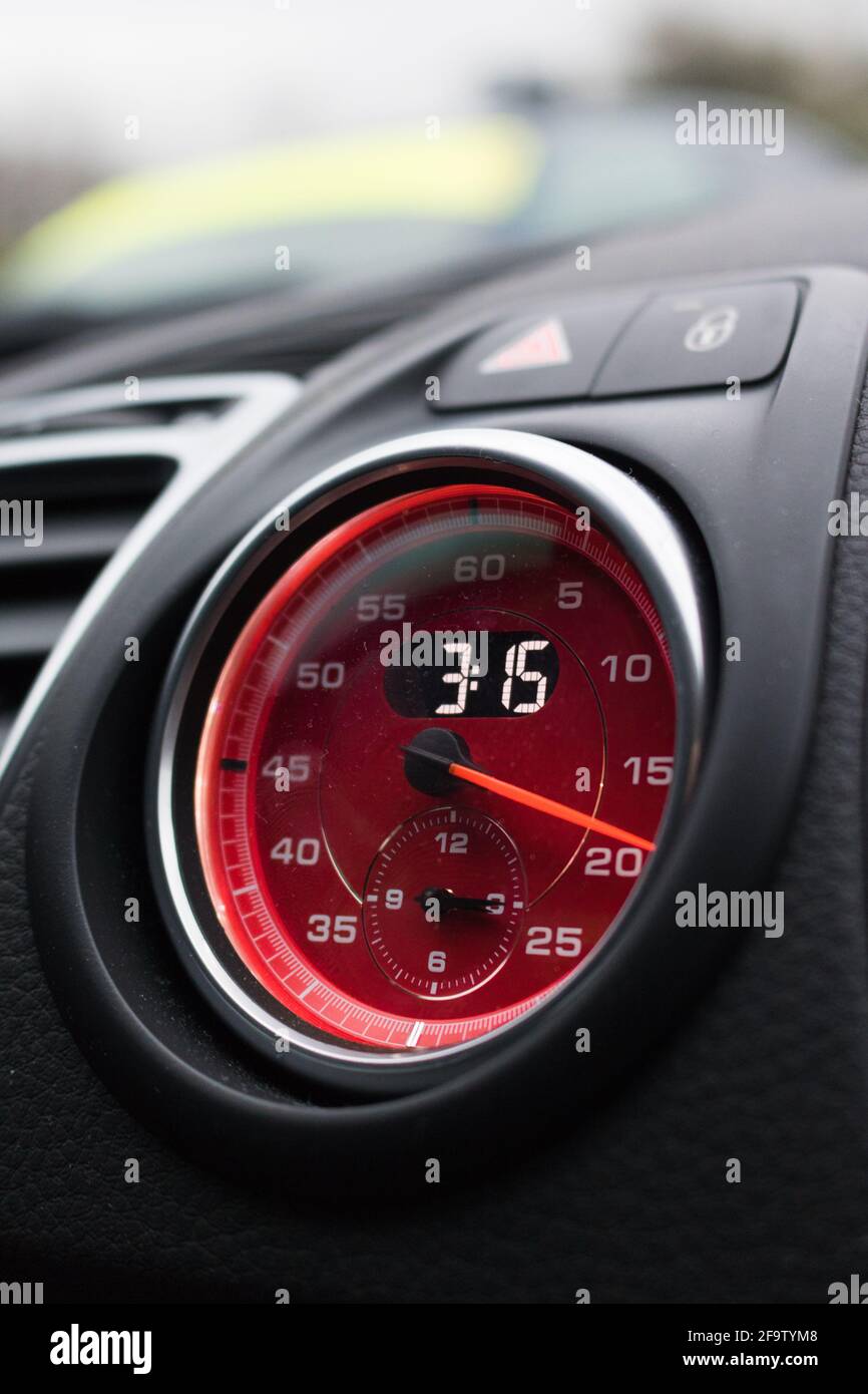 A Red Face Optional Porsche Lap Timer With Digital Clock On The Dashboard Of A 2015 Porsche Cayman GTS. Stock Photo